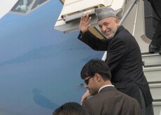 Hamid Karzai, President of Afghanistan, waves as he boards his aircraft to depart the United States Aug. 8. President Karzai was in the United States over the weekend for a two-day meeting with President George W. Bush at Camp David.