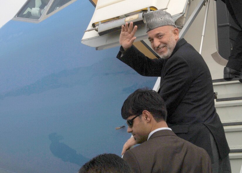 Hamid Karzai, President of Afghanistan, waves as he boards his aircraft to depart the United States Aug. 8. President Karzai was in the United States over the weekend for a two-day meeting with President George W. Bush at Camp David.