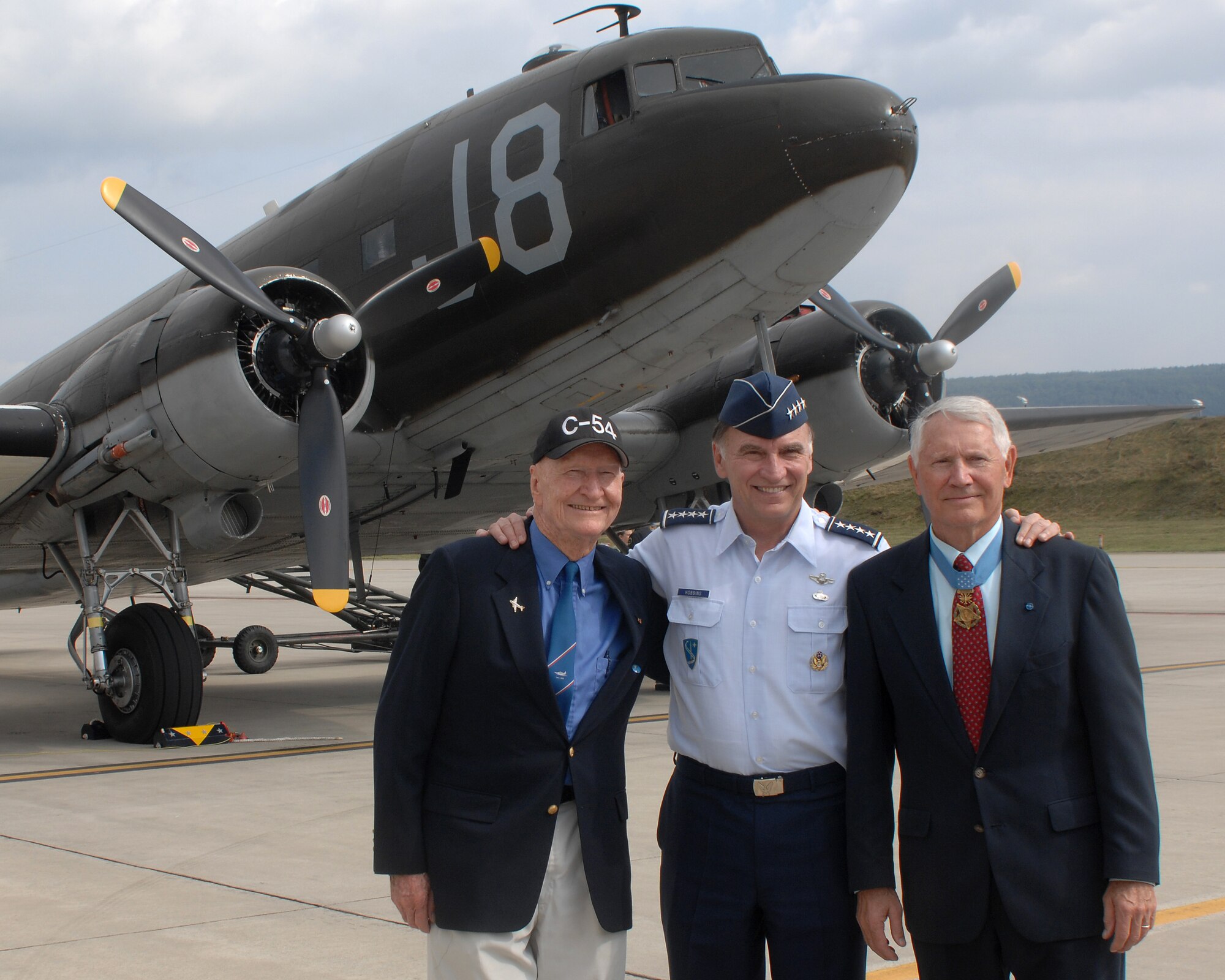 (Left to right) Col. (Ret.) Gail Halvorsen, Berlin Airlift Candy Bomber, Gen. Tom Hobbins, U.S. Air Forces in Europe Commander, and Lt. Col. (Ret.) Leo Thorsness (left), Medal of Honor recipient, pose for a photo in front of the historic C-47 Dakota, during U.S. Air Forces in Europe 60th Air Force anniversary celebration, August 11, 2007, at Ramstein Air Base, Germany. (U.S. Air Force photo/ Airman 1st Class Kenny Holston)
