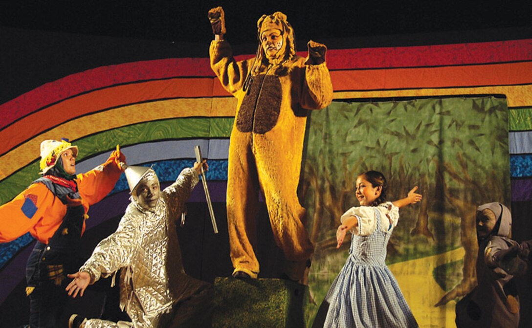 The Cowardly Lion, played by Erin Crow, meets with the Scarecrow, Tin Man, Dorothy and Toto the dog, during the Missoula Children's Theater's rendition of the famed 'The Wizard of Oz' at the base theater Aug.4.