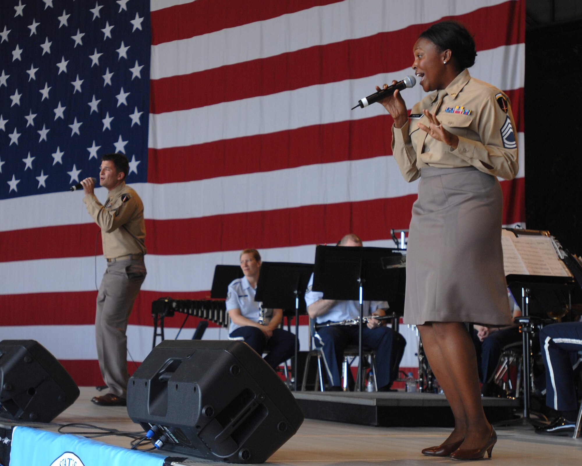 Staff Sgt. Keisha Gwin-Goodin and Staff Sgt. Craig Bowman, U.S. Air Forces in Europe Band vocalists, dressed in vintage Air Force uniforms to perform for the crowd attending the U.S. Air Forces in Europe 60th Air Force anniversary celebration, August 11, 2007 at Ramstein Air Base, Germany.   (U.S. Air Force photo/Airman 1st Class Kenny Holston)