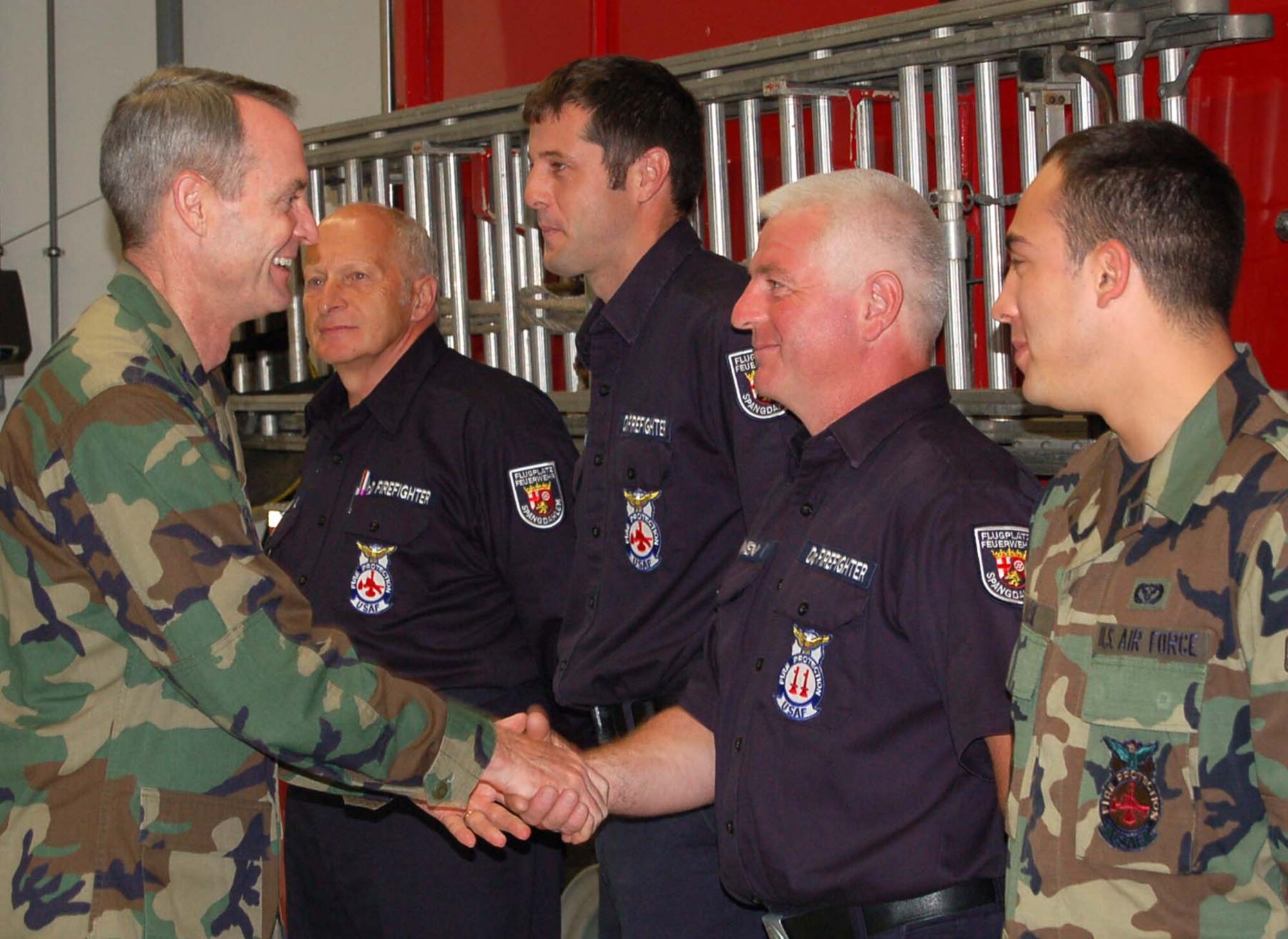 SPANGDAHLEM AIR BASE, Germany – Willy Sonnen, 52nd Fighter Wing commander, gives his commander’s coin as a token of appreciation to Airman 1st Class Dan Maese, 52nd Civil Engineer Squadron firefighter. Mr. Sonnen was one of the firefighters who responded to a rescue saving the life of a fellow Saber July 12. (US Air Force photo/Staff Sgt. Tammie Moore)