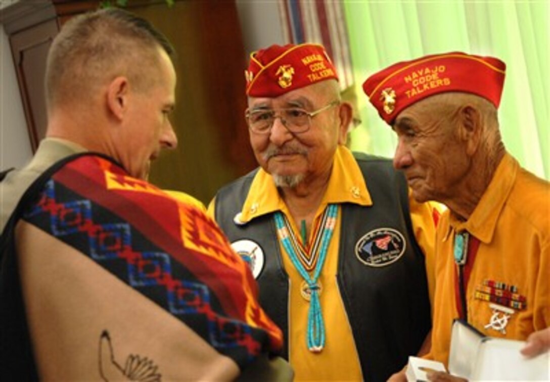 Chairman of the Joint Chiefs of Staff Gen. Peter Pace (left), U.S. Marine Corps, talks with Navajo Code Talkers after they presented him with a Navajo blanket in the Pentagon on Aug. 10, 2007.  Code Talkers were Native American Marines who served in World War II and developed a communications code based on their native language.  