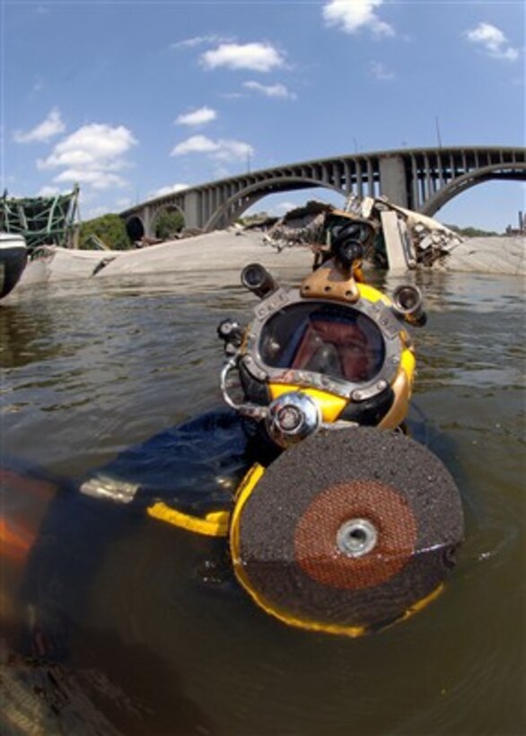 Navy Diver Petty Officer 1st Class Joshua Harsh prepares to submerge on a salvage dive at the site of the I-35 bridge collapse on the Mississippi River in Minneapolis, Minn., on Aug. 11, 2007.  Harsh is attached to Mobile Diving and Salvage Unit 2 from Naval Amphibious Base Little Creek, Va.  MDSU-2 is assisting other federal, state, and local authorities managing disaster and recovery efforts at the site of the I-35 bridge collapse.  