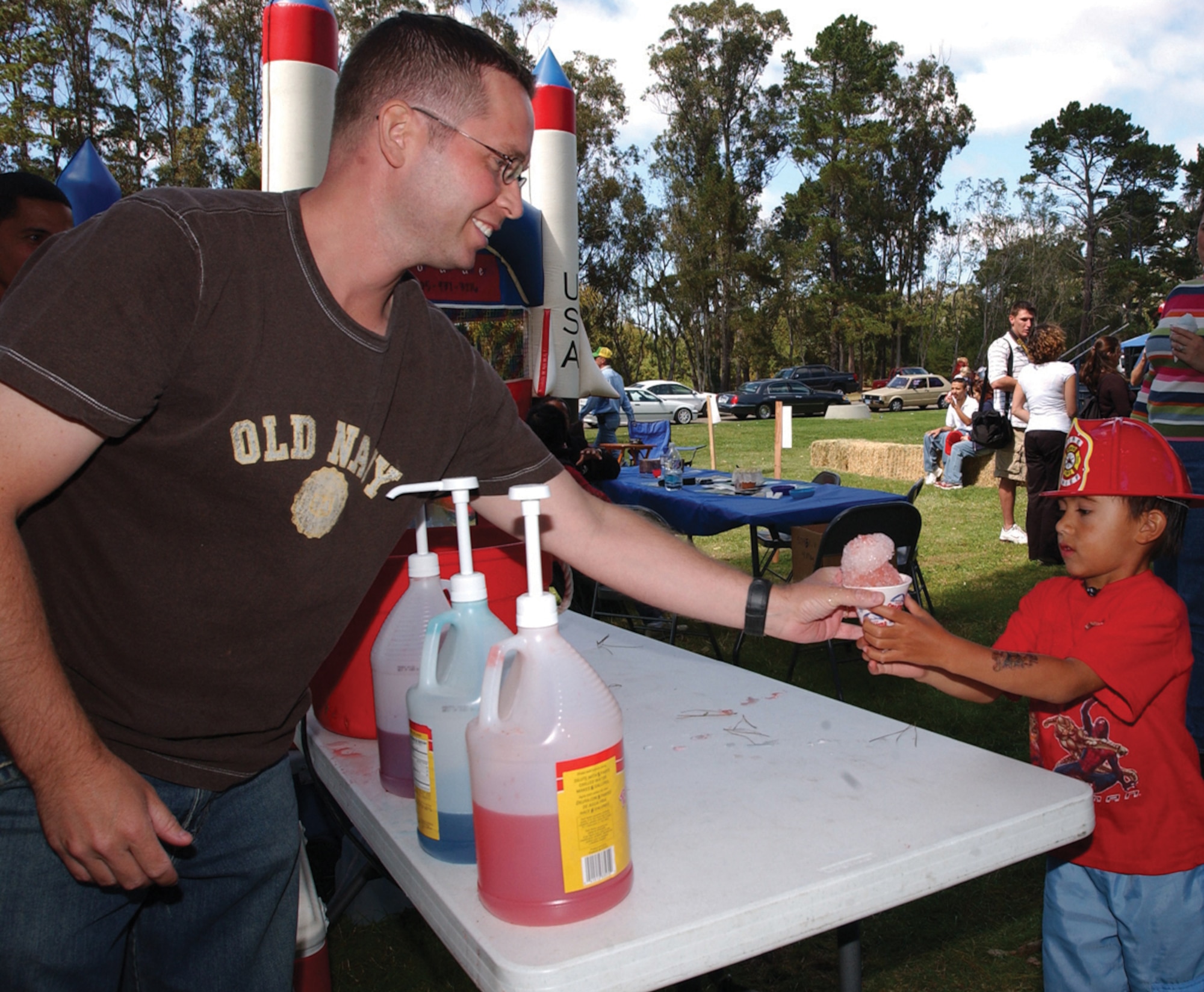 VANDENBERG AIR FORCE BASECanadian Air Force Sgt. Marc Corriveau, 533rd
Training Squadron, treats Jacob Cronin, 5, to a snow
cone during the 17th annual Texas Blowout Barbecue
held in Cocheo Park Sept. 9, 2005.(U.S. Air Force photo by Staff Sgt. Orly Tyrell) 