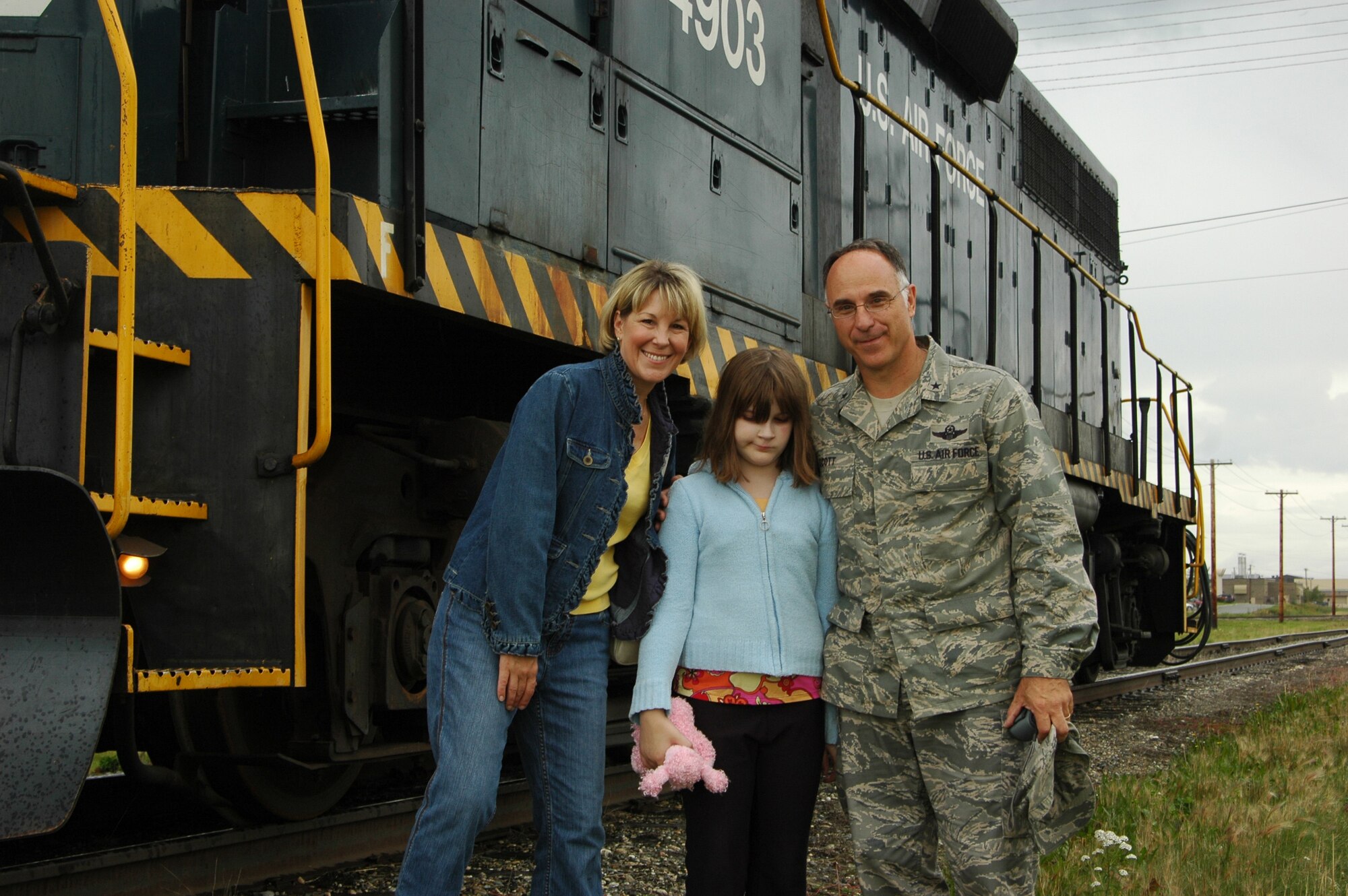 EIELSON AIR FORCE BASE, Alaska--Lisa, Rachel and Brig. Gen. Dave Scott, 354th Fighter Wing commander, pose for a photo after their complimentary train ride Aug. 14 as part of a farewell to General Scott and his family. (U.S. Air Force photo by Tech. Sgt. William Farrow)