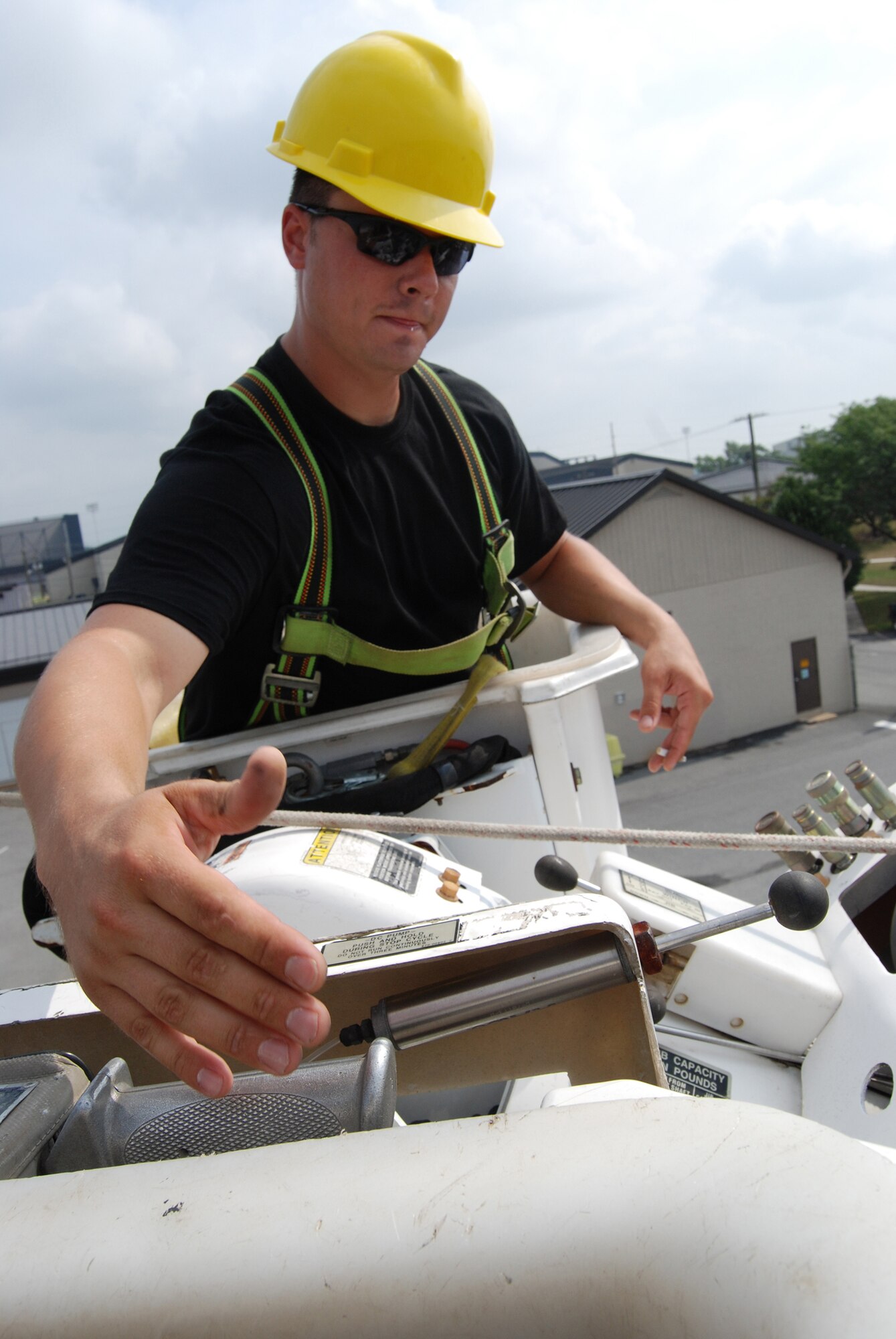 DOVER AIR FORCE BASE, Del. -- High up in the air, Staff Sgt. Ivan Fullerton, an electrician with the 512th Civil Engineer Squadron here, operates the boom arm of an electric bucket truck.  512th CES members receive annual refresher training on the vehicle in order to safely operate it both on base and at a deployed location. (U.S. Air Force photo/Staff Sgt. Steve Lewis)