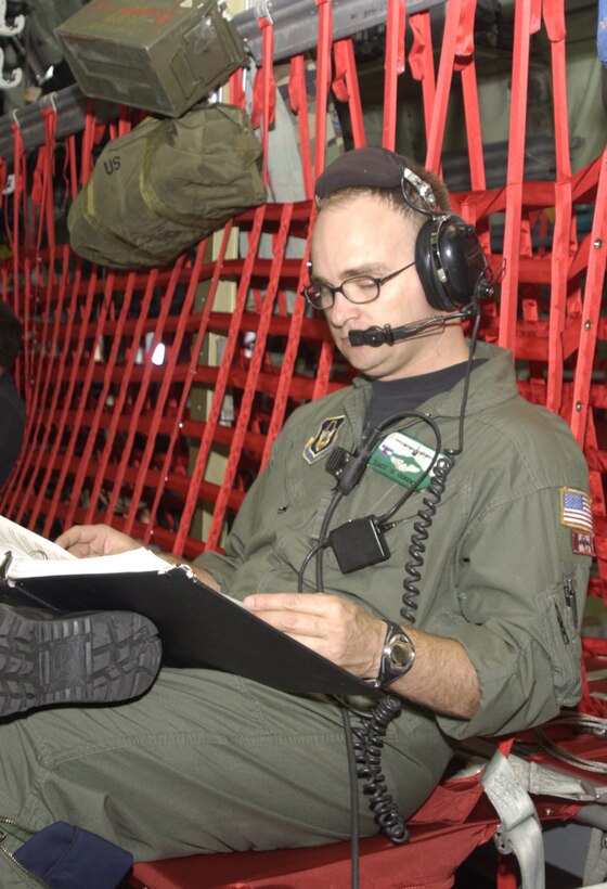 PETERSON AIR FORCE BASE, Colo. -- Staff Sgt. Scott Gordon, 731st Airlift Squadron loadmaster, studies his Air Force instruction en route to Joint Airborne/Air Transportability Training at Naval Air Station Whidbey Island, Wash., Aug. 11. Sergeant Gordon is recertifying on the JA/AAT missions after being grounded for several months due to a shoulder injury he suffered while deployed to Southwest Asia in support of U.S. Central Command operations. The benefits of flying JA/AAT missions are two-fold, allowing aircrews an opportunity to hone their aircrew currency skills while providing members of other services a chance to meet training requirements for high altitude, low opening and static line parachute jumps.  (U.S. Air Force photo/Tech. Sgt. Tim Taylor)