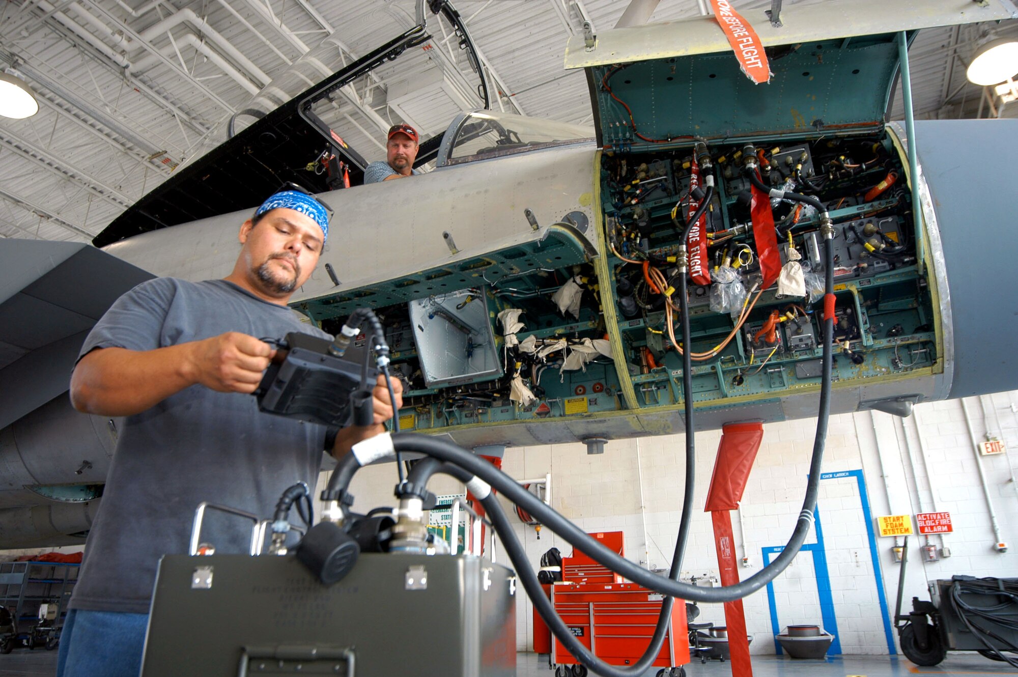 John Hysell and Henry Sparks get a look at one of the automated flight test control systems of an F-15 Eagle during a demonstration Aug 1 at Robins Air Force Base, Ga. The tester plugs into the F-15, like hooking up a car engine to a computer to discover engine trouble. Mr Hysell and Mr. Sparks are aircraft mechanics. (U.S. Air Force photo/Sue Sapp) 
