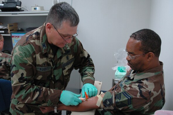 YOUNGSTOWN AIR RESERVE STATION, Ohio — Air Force Reserve Colonel Ronnie Roberts, commander of the 910th Medical Squadron, draws a blood sample from Senior Master Sgt. Raleigh Forte, NCOIC of Readiness for the 910th Services Squadron, during Sergeant Forte's annual physical August 4.  "We need and appreciate maximum support from all members of the wing to keep our medical readiness numbers up where they should be for the wing," said Col. Roberts. "Tasks such as keeping our yearly physicals and other medical/dental requirements up-to-date are critical to our mission readiness overall," he said.  Col. Roberts is also a registered nurse in his civilian capacity at the Ohio State Penitentiary Maximum Security Prison in Hubbard, Ohio.  U.S. Air Force photo/Master Sgt. Bryan Ripple