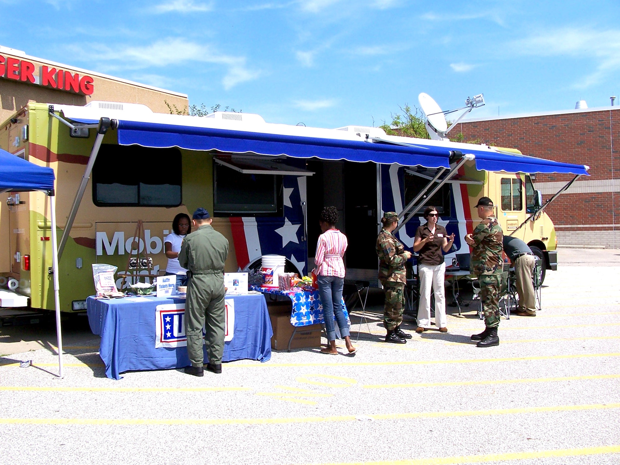 Members of the Michigan Air National Guard and other visitors to the base exchange at Selfridge Air National Guard Base, Mich., stop by the Mobile United Service Organizations' station Aug. 11. The canteen is one of three such vehicles the USO began using this year to bring the USO to servicemembers who may not regularly come in contact with the organization. There are no USO facilities in Michigan. The mobile center offers a TV lounge, wireless Internet access and other recreational offerings. (U.S. Air Force photo/Staff Sgt. Samara Taylor) 
