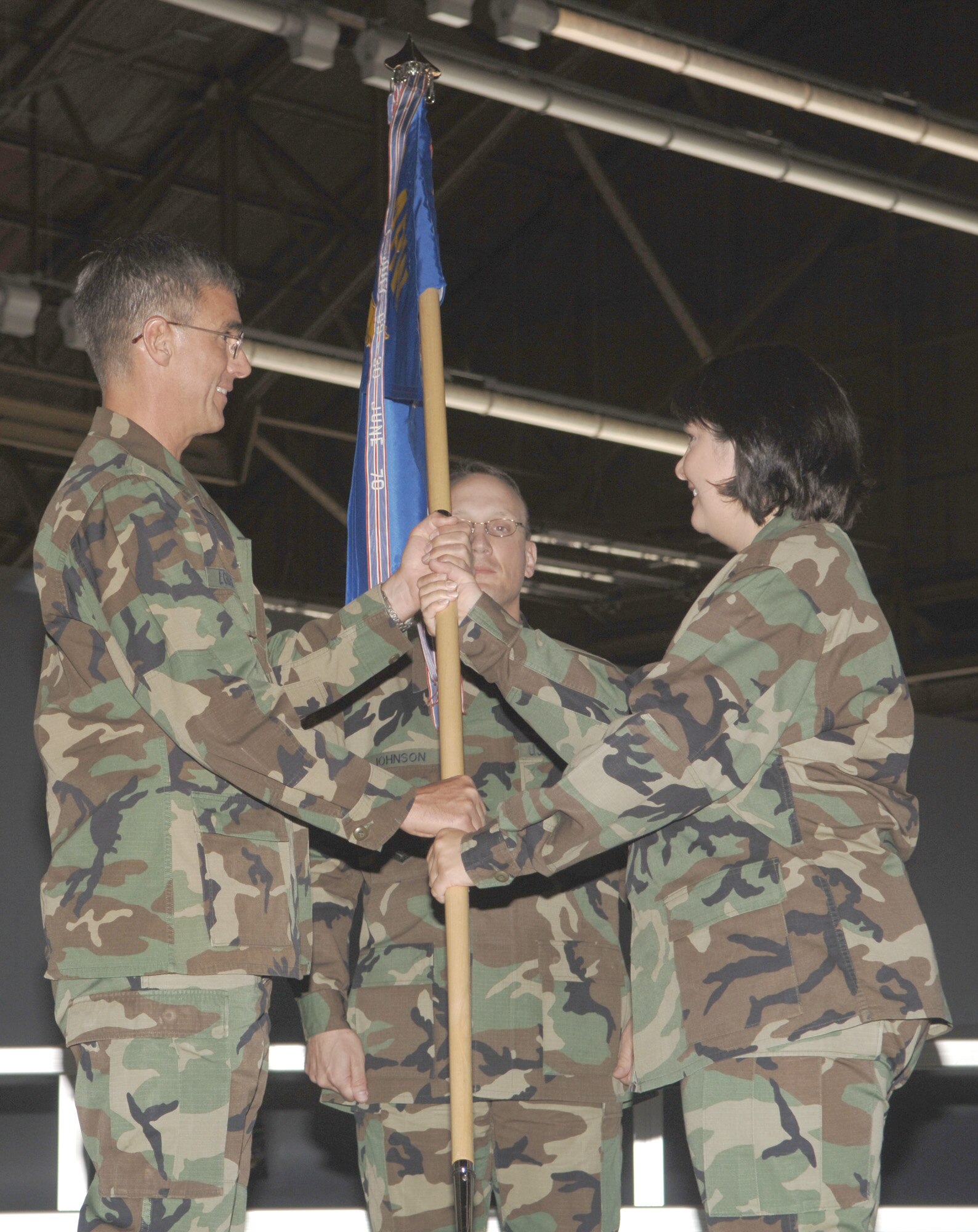 FAIRCHILD AIR FORCE BASE, Wash. – Maj. Christine Byers, the new 92nd Maintenance Squadron commander, receives the squadron flag from Col. Robert Egbert, 92nd Maintenance Group commander, during the change-of command ceremony Aug. 9. Maj. Byers follows in the footsteps of outgoing squadron commander Lt. Col. Matthew Mangan. (U.S. Air Force photo / Senior Airman Chad Watkins)