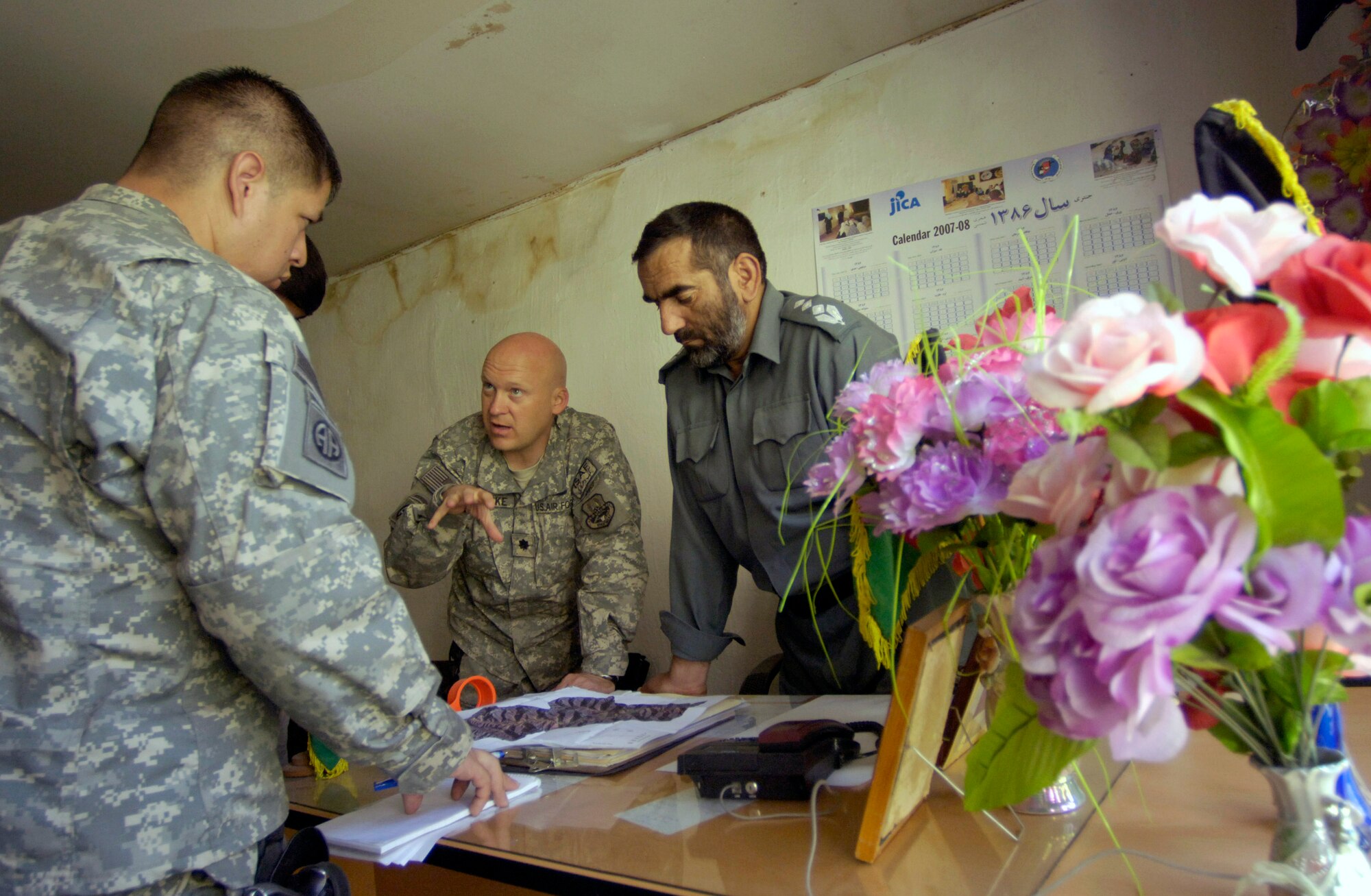 Staff Sgt. Andre Sanchez-Romero (left) and Lt. Col. Christopher Luedtke meet with newly appointed Dara district police chief Khalil Rahman Aug. 5 to discuss security concerns in the strategically important district in Panjshir province, Afghanistan.  Colonel Luedtke is the commander of the Panjshir Provincial Reconstruction Team and Sergeant Sanchez-Romero is a security forces Airman who works as a mentor with the Afghan local police.  (U.S. Air Force photo/Master Sgt. Jim Varhegyi)