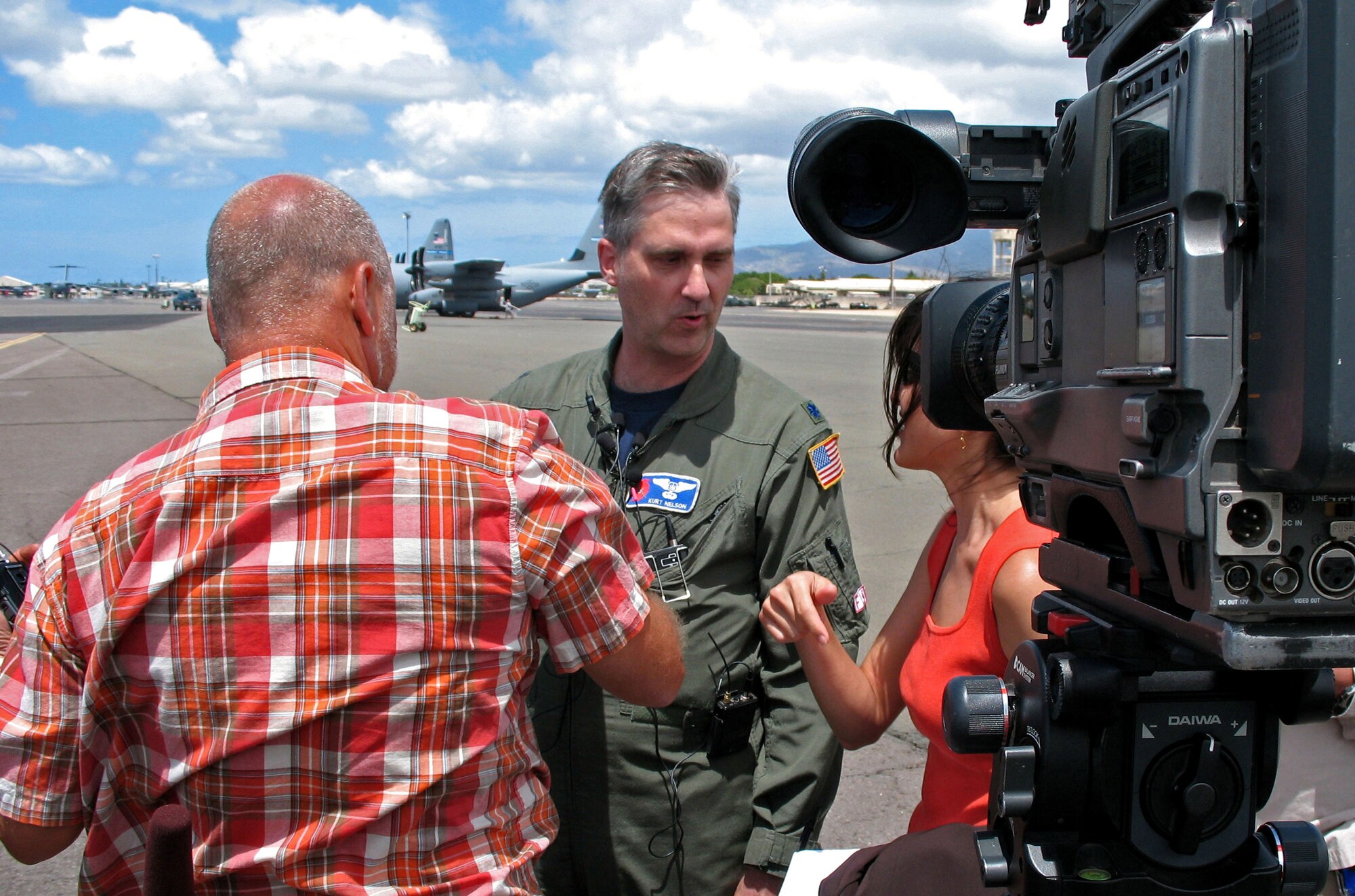 Lt. Col. Kurt Nelson talks with reporters Aug. 13 on the flightline at Hickam Air Force Base, Hawaii. Colonel Nelson is an airborne reconaissance weather officer with the 53rd Weather Reconnaissance Squadron out of Keesler Air Force Base, Miss. He and and several other "Hurricane Hunters" are flying C-130 Hercules weather reconnaissance missions out of Hickam AFB, Hawaii, to track Hurricane Flossie, a Category 4 storm moving toward Hawaii. (U.S. Air Force photo/Tech. Sgt. Chris Vadnais)

