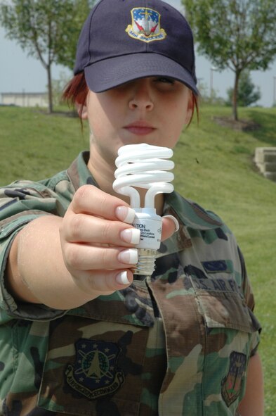 This 341st Missile Wing Airman holds a compact fluorescent light bulb which uses 75 percent less energy than incandescent bulbs and lasts six to 10 times longer, according to www.energystar.gov. (U.S. Air Force photo/Senior Airman Eydie Sakura)