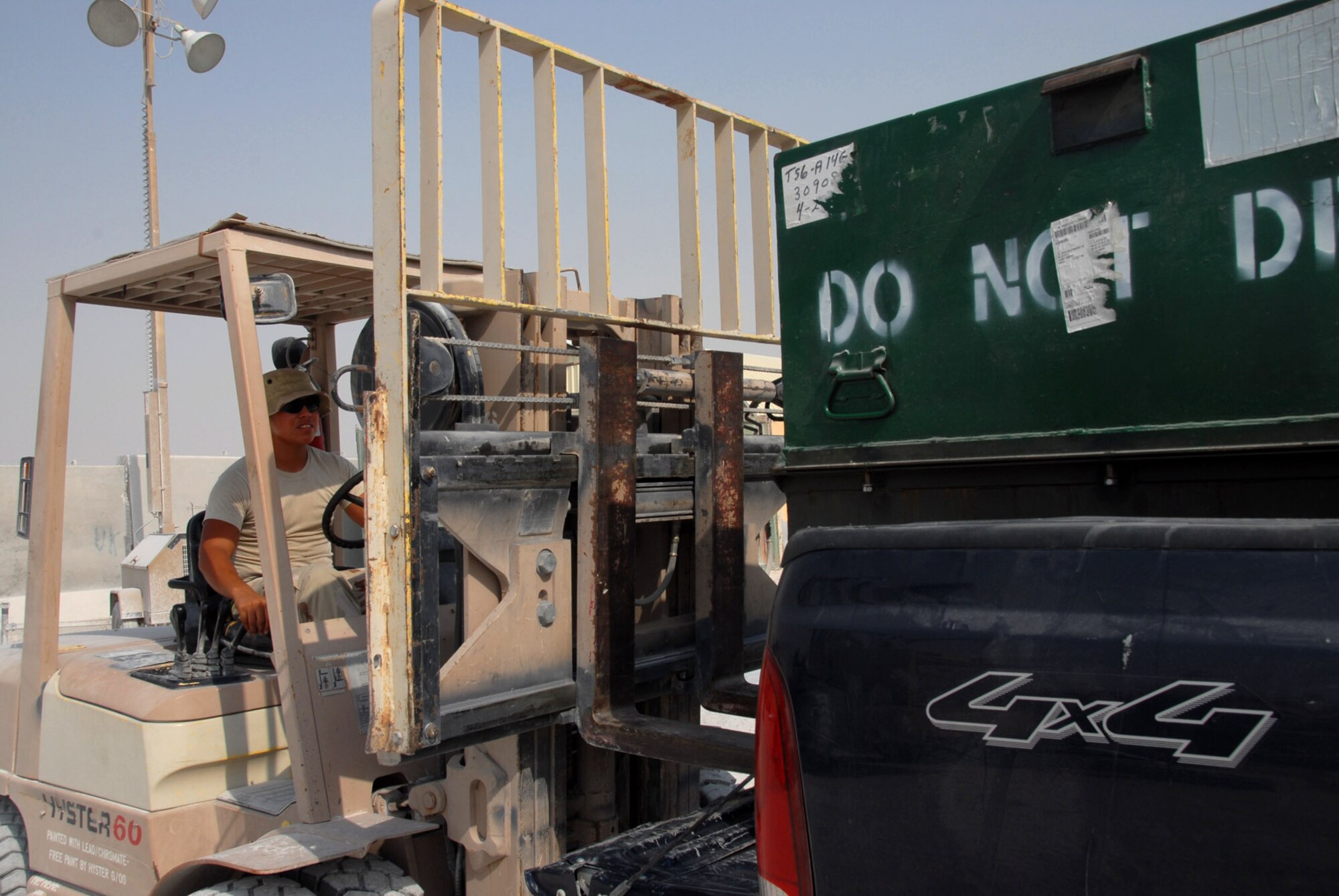 Senior Airman Nick Mendoza uses a forklift to unload a container of cargo from a pickup truck Aug. 8 in Southwest Asia. Airman Mendoza is assigned to the 379th Expeditionary Logistics Readiness Squadron Cargo Movement Flight. Airmen of the flight ship anything the military uses anywhere in the world. (U.S. Air Force photo/Airman 1st Class Ashley Tyler) 
