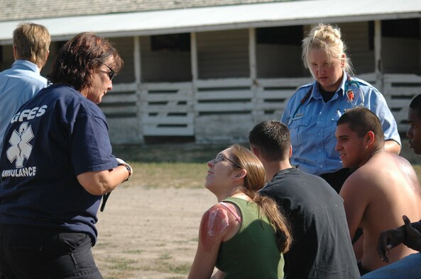 Paramedics from Great Falls Emeregency Services assess the wounds of the role-players. One paramedic talks to 1st Lt. Crystal Wintersteen,  341st Missile Security Forces Squadron, while the other speaks with Airmen 1st Class Logan Fitzgerald and Anthony Avalos, 341st MSFS. All the role-player victims for Operation Great Falls were volunteers from Malmstrom. (U.S. Air Force photo / Airman 1st Class Emerald Ralston)