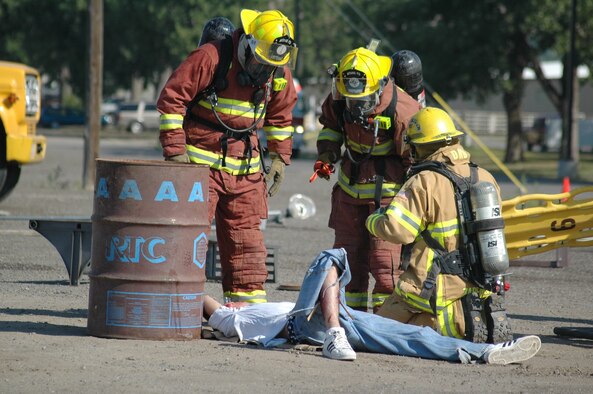 Members of the Montana Air National Guard fire department and the Great Falls fire department work together during triage on a role-player victim. One of the reasons behind Operation Great Falls, a joint, off-base emergency response exercise, was to see how members of different agencies worked together in a distaster scenario. (U.S. Air Force photo / Airman 1st Class Emerald Ralston)