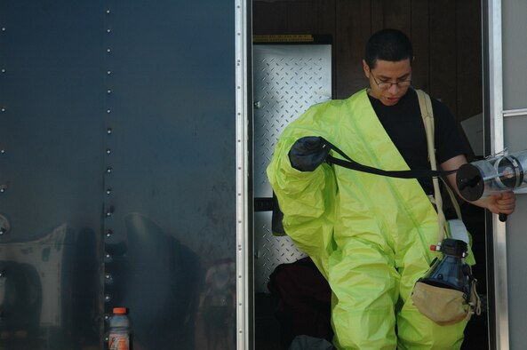 Senior Airman Johnny Mosquera, 341st Medical Operations Squadron bioenvironmental engineering specialist, suits up in preparation for his role in Operation Great Falls, a joint, off-base emergecny response exercise held at the Montana Expo Park Aug. 9. (U.S. Air Force photo / Airman 1st Class Emerald Ralston)