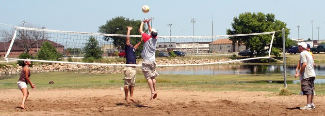 WHITEMAN AIR FORCE BASE, M.O. - Team Whiteman members play in a volleyball tournament during the 14th Annual Enlisted Luau at Ike Skeleton Park Aug 10. The luau was set up by the Whiteman Top Three for enlisted active duty, Guard, Reserve and civilian equivalents and their families. (U.S. Air Force Photo/Airman 1st Class Stephen Linch)