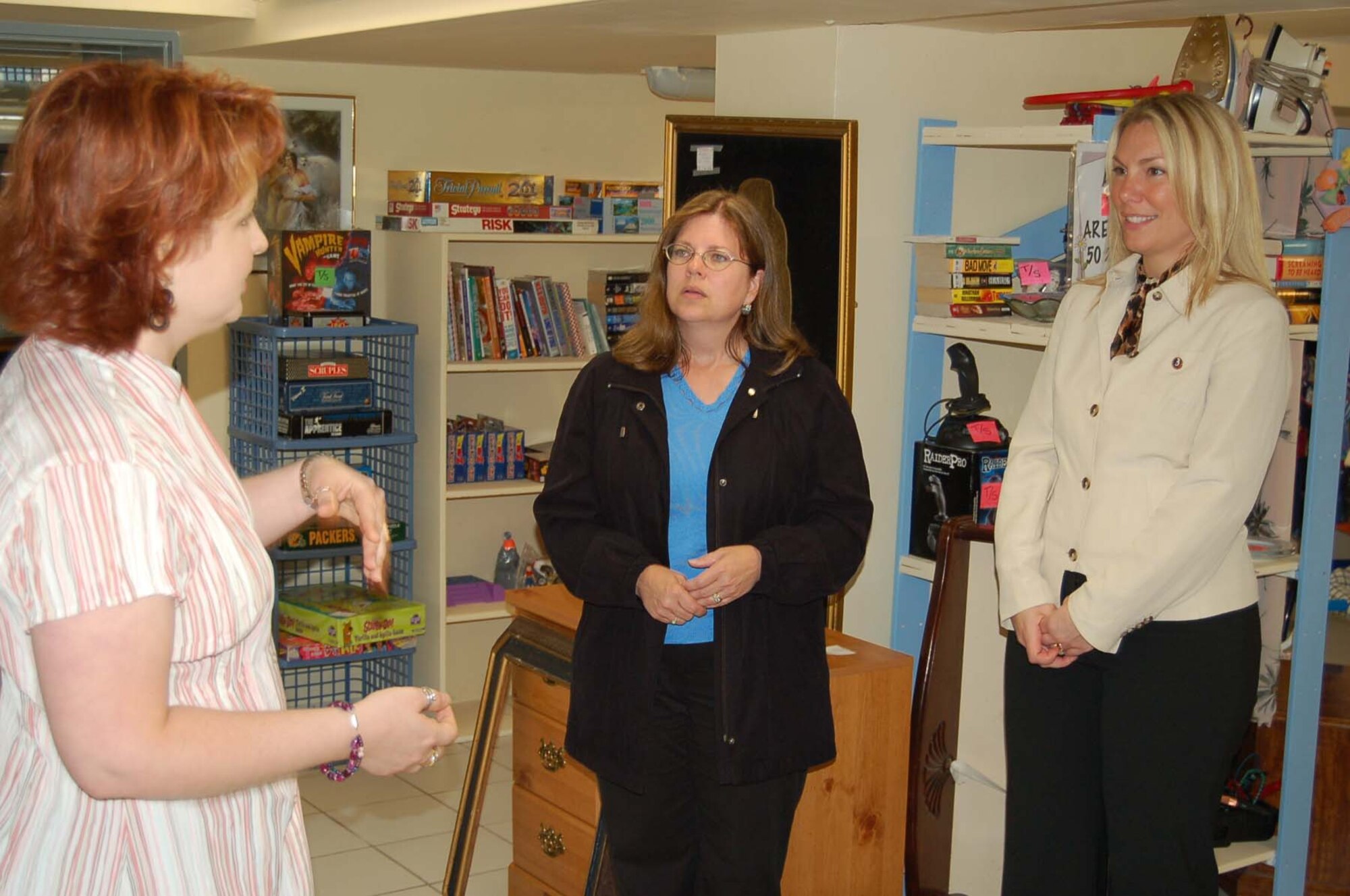 SPANGDAHLEM AIR BASE, Germany -- Kellie King, Spangdahlem Spouses and Enlisted Military Club Thrift Shop manager, talks to Pam Clarke, wife of 52nd Fighter Wing Command Chief Master Sgt. Vance Clarke, and Peggy Klukas, wife of 3rd Air Force Command Chief Master Sgt. Martin Klukas, about the Spangdahlem Thrift Shop which recently reopened under new management. (U.S. Air Force photo/Staff Sgt. Mike Lemorie)