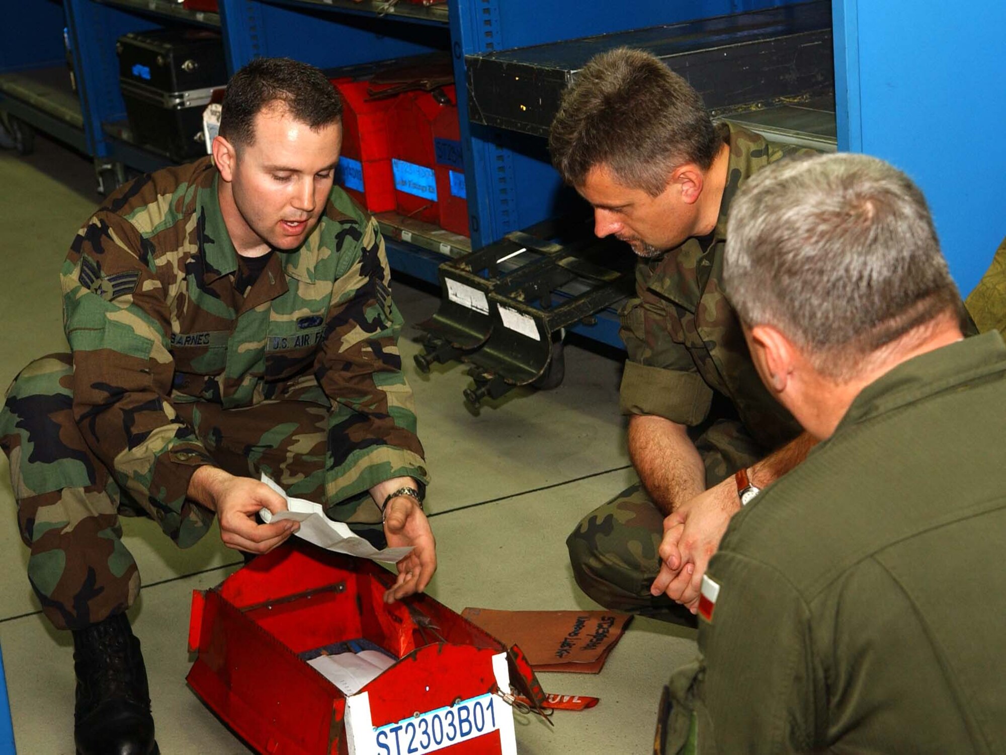 SPANGDAHLEM AIR BASE, Germany – Senior Airman Joshua Barnes, 52nd Aircraft Maintenance Squadron, explaining to Polish air force Maj. Krysztof Pusz and Col. Roscislaw Stepaniuk how tools are accounted for by verifying the Master Inventory Listing for each tool assigned to the Consolidated Tool Kit. This process ensures maintainers do not leave tools in an airplane causing unsafe conditions for the pilot and the aircraft while in flight. Members of the Polish air force spent two days visiting Spangdahlem to learn about the base operations and support activities Aug. 7. (U.S. Air Force photo/Airman 1st Class Allen Pollard)
