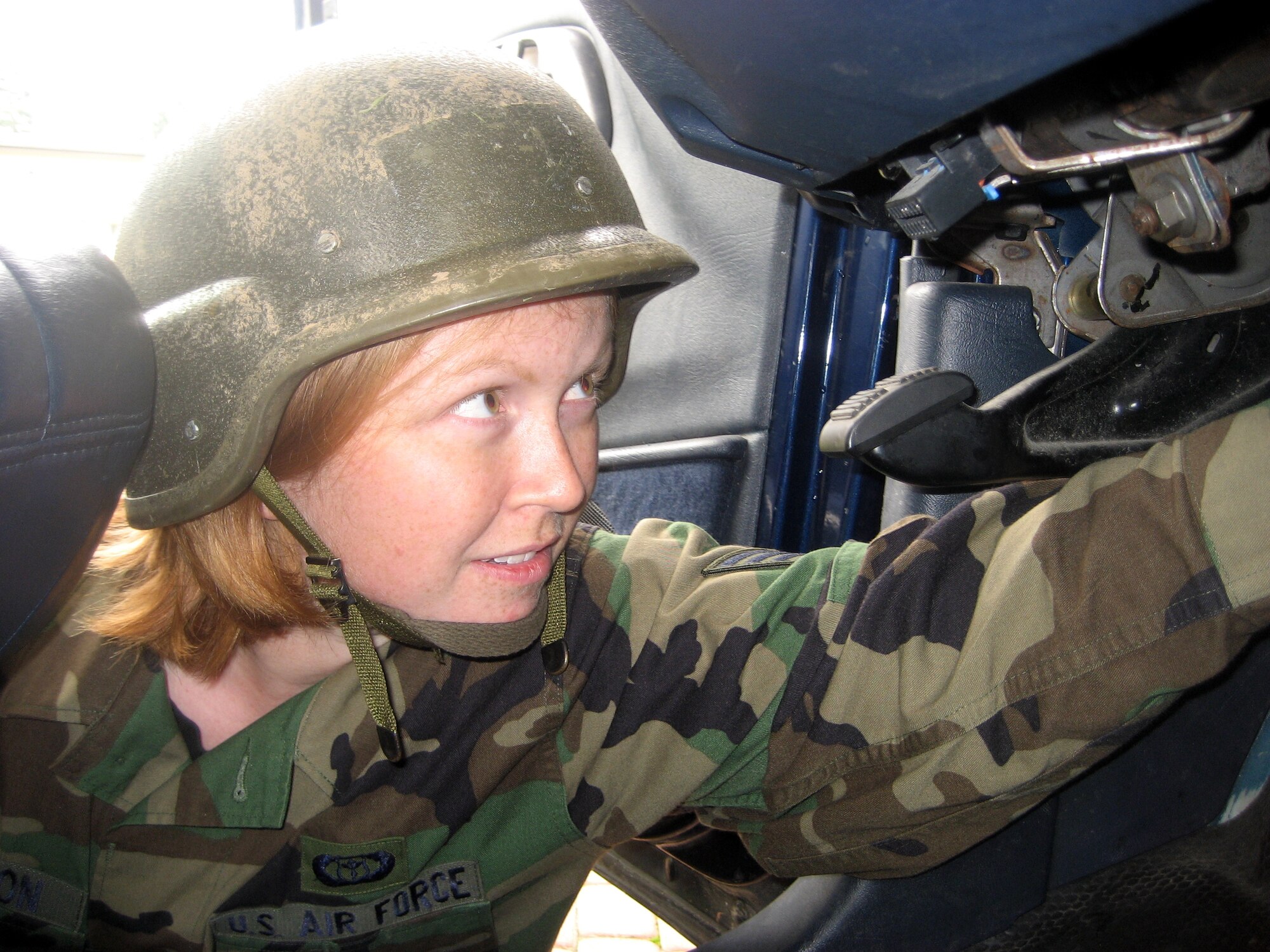 SPANGDAHLEM AIR BASE, Germany -- Staff Sgt. Amanda Peterson, 52nd Operations Support Squadron, searches for a simulated explosive device in the front seat of a vehicle during an Expeditionary Combat Skills class Aug. 10. Sergeant Peterson and her fellow students were instructed on the proper way to search a vehicle. (U.S. Air Force photo/Staff Sgt. Andrea Knudson)
