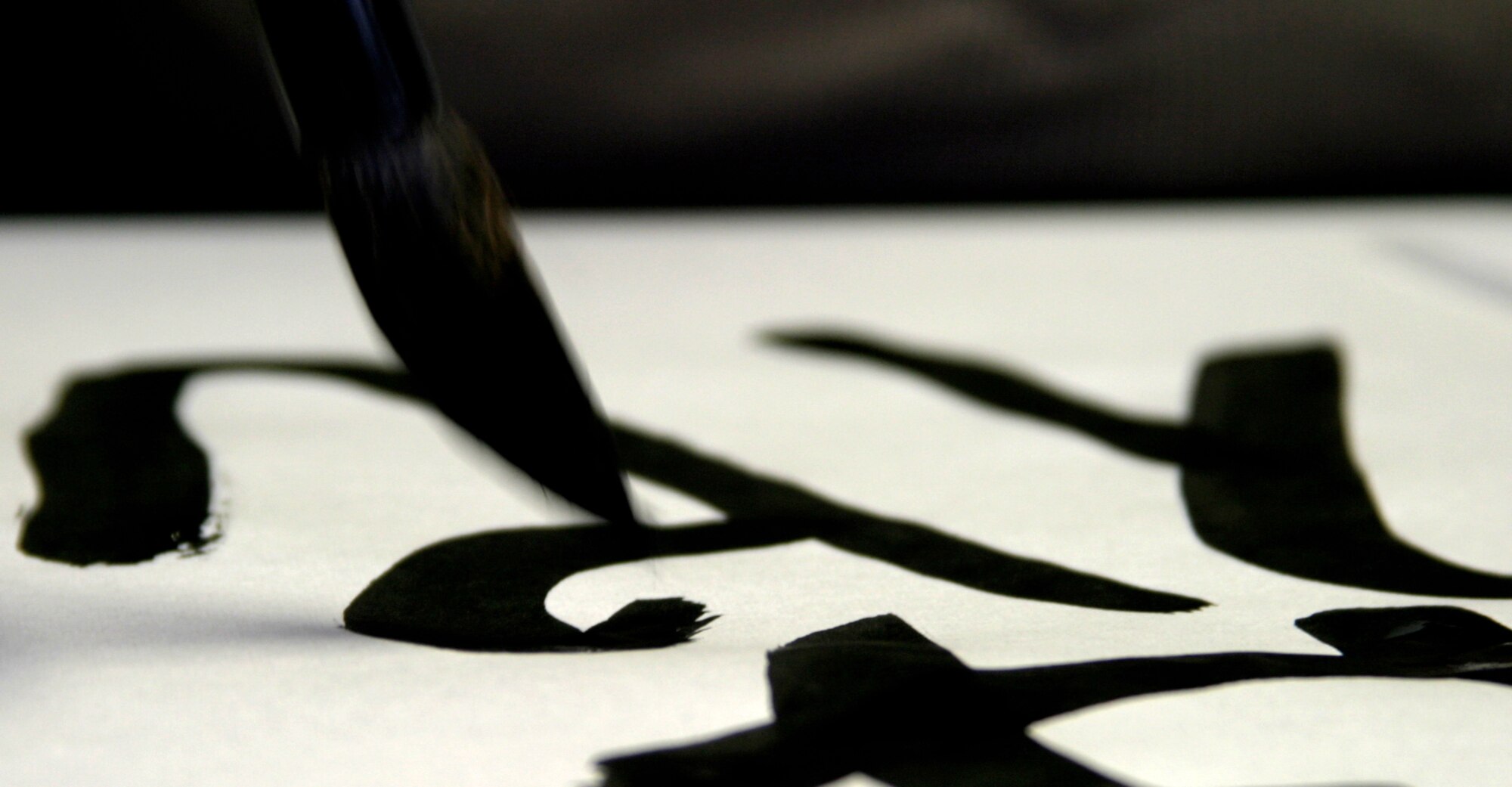Kunii Takezaki, Japanese calligraphy master, demonstrates various calligraphy brush techniques for Kadena teens Aug. 10 at the Airman and Family Readiness Center. The two-hour calligraphy class was the fifth in a series of free cultural classes designed to expose teens to various elements of Japanese culture. 
(U.S. Air Force photo/Senior Airman Nestor Cruz)
