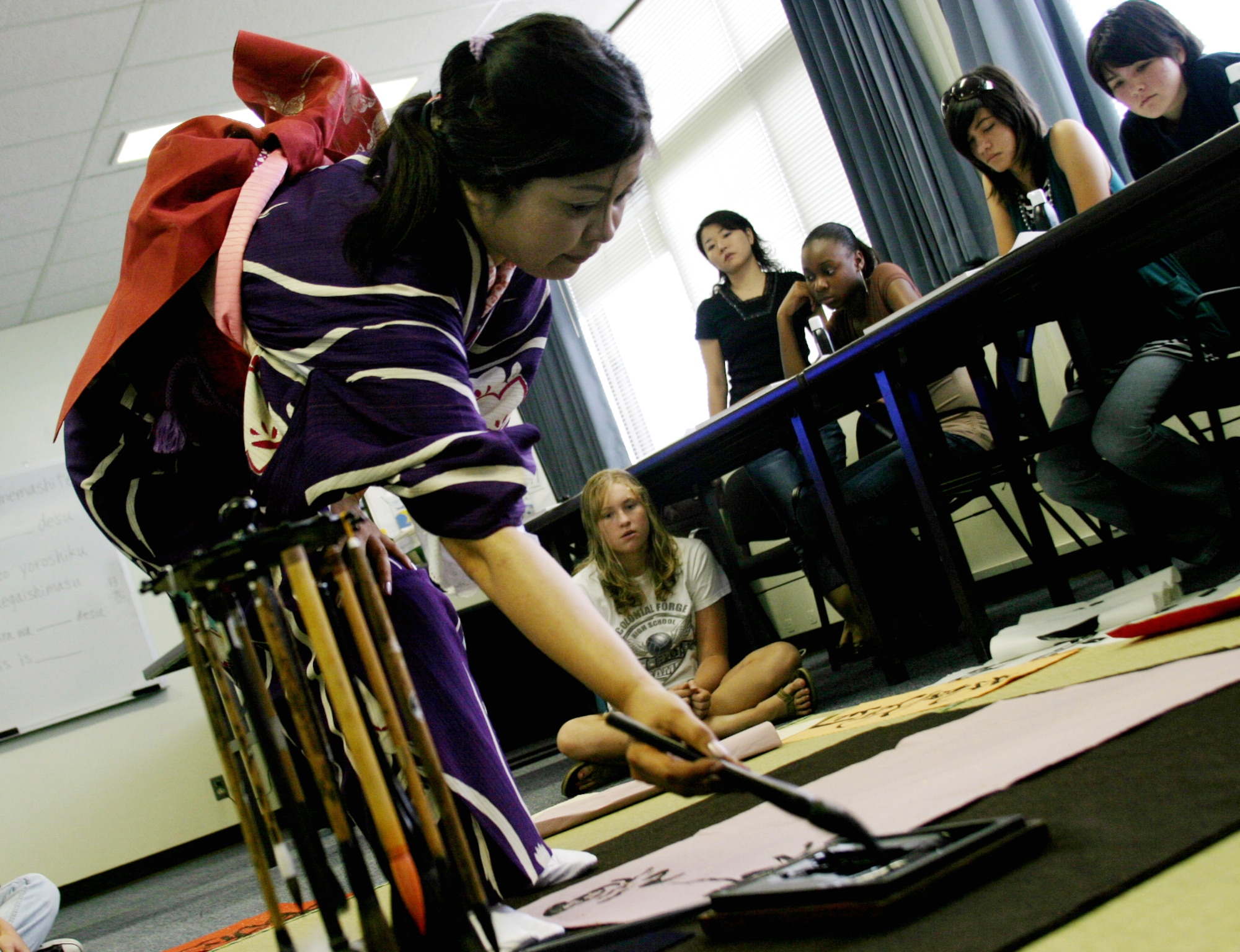 Kunii Takezaki, Japanese calligraphy master, demonstrates various calligraphy brush techniques for Kadena teens Aug. 10 at the Airman and Family Readiness Center. The two-hour calligraphy class was the fifth in a series of free cultural classes designed to expose teens to various elements of Japanese culture. The cultural class series was an activity idea resulting from the teen town hall meeting in June.
(U.S. Air Force photo/Senior Airman Nestor Cruz)
