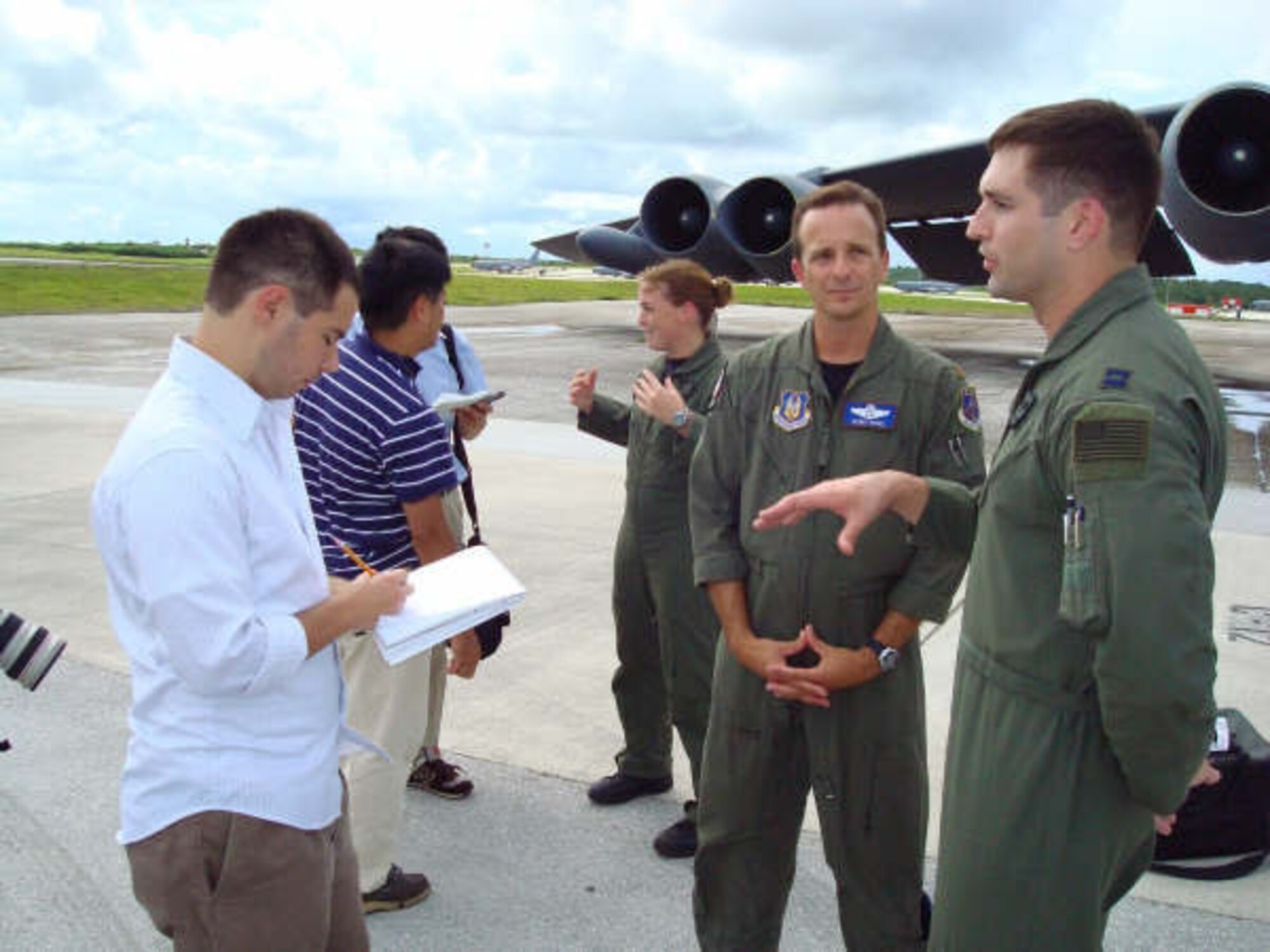 Capt. Matt Baker, a pilot with the 20th Expeditionary Bomb Squadron, explains to Brett Kelman, a reporter for Pacific Daily News, about the support the active duty and reserve crews shared during the Valiant Shield exercise as  Maj. Dennis Heinz, a reservist with the 93rd Bomb Squadron looks on. The two units assigned to Barksdale Air Force Base used Andersen as an operational staging platform during Valiant Shield combining both active duty and Air Force reserve assets. (U.S. Air Force photo by Master Sgt. Art Webb)