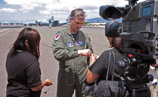 Lt. Col. Kurt Nelson, an airborne reconaissance weather officer with the 53rd Weather Reconaissance Squadron out of Keesler Air Force Base, Mississippi, talks with reporters on the flightline at Hickam Air Force Base, Hawaii on August 13, 2007. Lt. Col. Nelson and several other "Hurricane Hunters" are flying C-130 weather recon missions out of Hickam to track Hurricane Flossie, a category 4 storm which is moving toward the Big Island of Hawaii. (US Air Force photo/Tech. Sgt. Chris Vadnais)