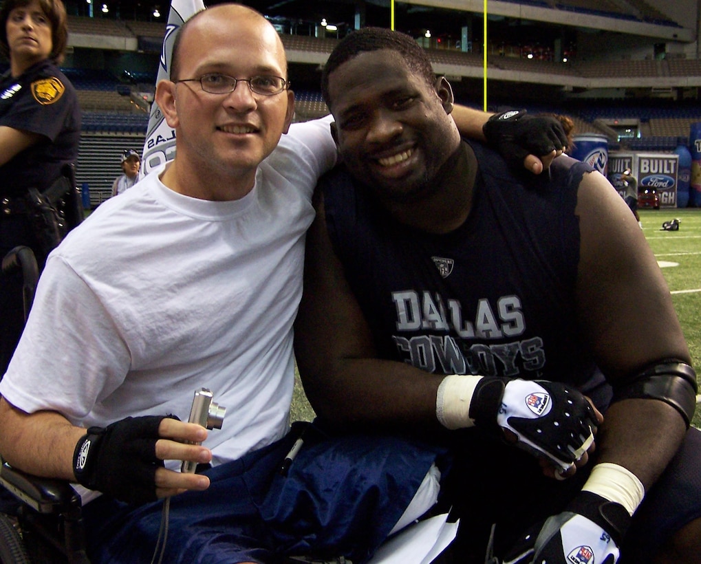Army Sgt. Daniel Cowart gets a hug from Dallas Cowboys defensive end Chris Canty. Cowart, who lost part of his leg while serving in Iraq, is recovering at Brooke Army Medical Center at Fort Sam Houston, Texas. Courtesy photo