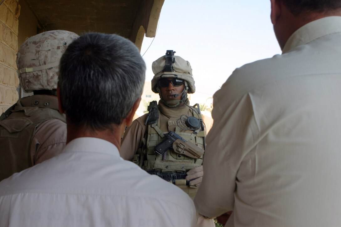 HUSAYBAH, Iraq ? Staff Sgt. Tarik A. Billingsley, a section leader for Viking Red section, Mobile Assault Platoon, Regimental Combat Team 2, speaks with the Al Qa?im court personal security detachment here.  The PSD was recently trained by Billingsley?s section to protect the local judges.