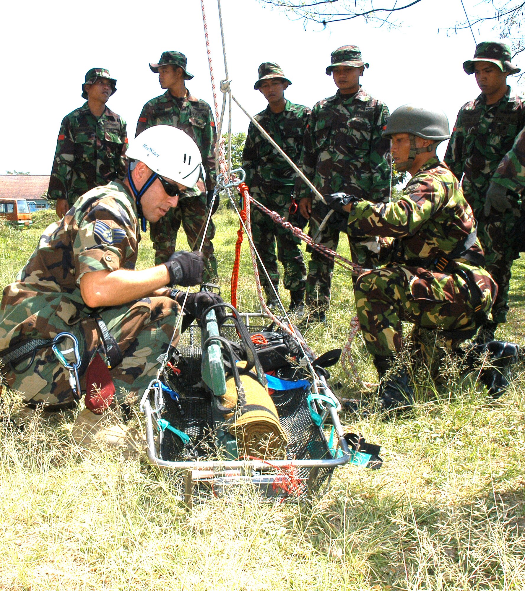 A pararescueman from the 320th Special Tactics Squadron, based at Kadena AB, Jaopan, helps members of the Indonesian Pashkas prepare a volunteer for a high angle rescue, one of the demonstrations during a recent training exercise between the 353rd Special Operations Group, and the Indonesian Air Force, during Exercise Teak Iron. (U.S. Air Force photo/Master Sgt. Marilyn C. Holliday)
