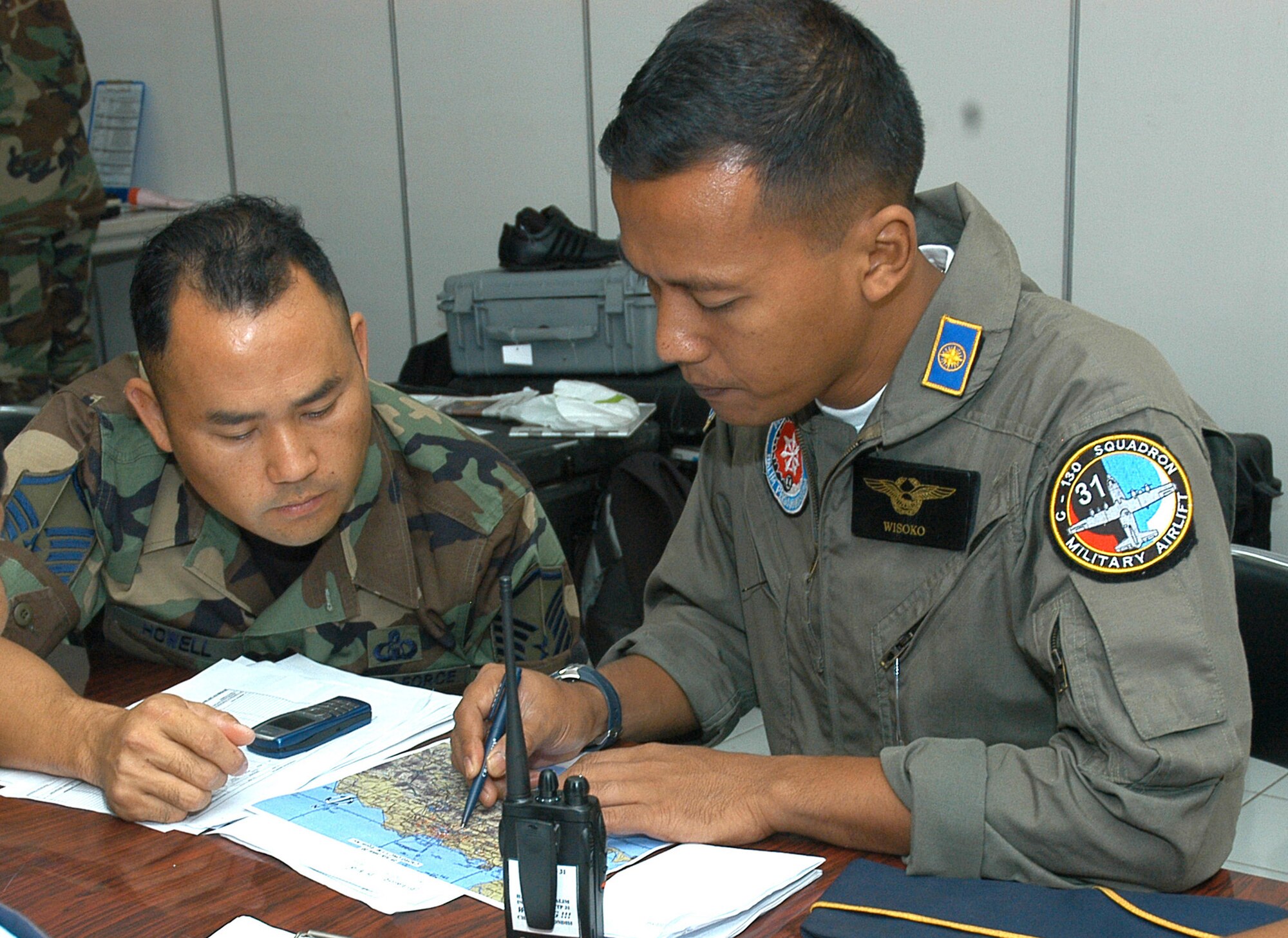 Master Sgt. Joe Howell, 353rd Special Operations Group air space controller, goes over control tower issues with Capt. Edwardus Wisoko, operations chief for Squadron 31 of the Indonesian Air Force.  The exchange was part of Exercise Teak Iron, an exercise between the U.S. Air Force and the Indonesian Air Force.
(U.S. Air Force photo/Master Sgt. Marilyn C. Holliday)