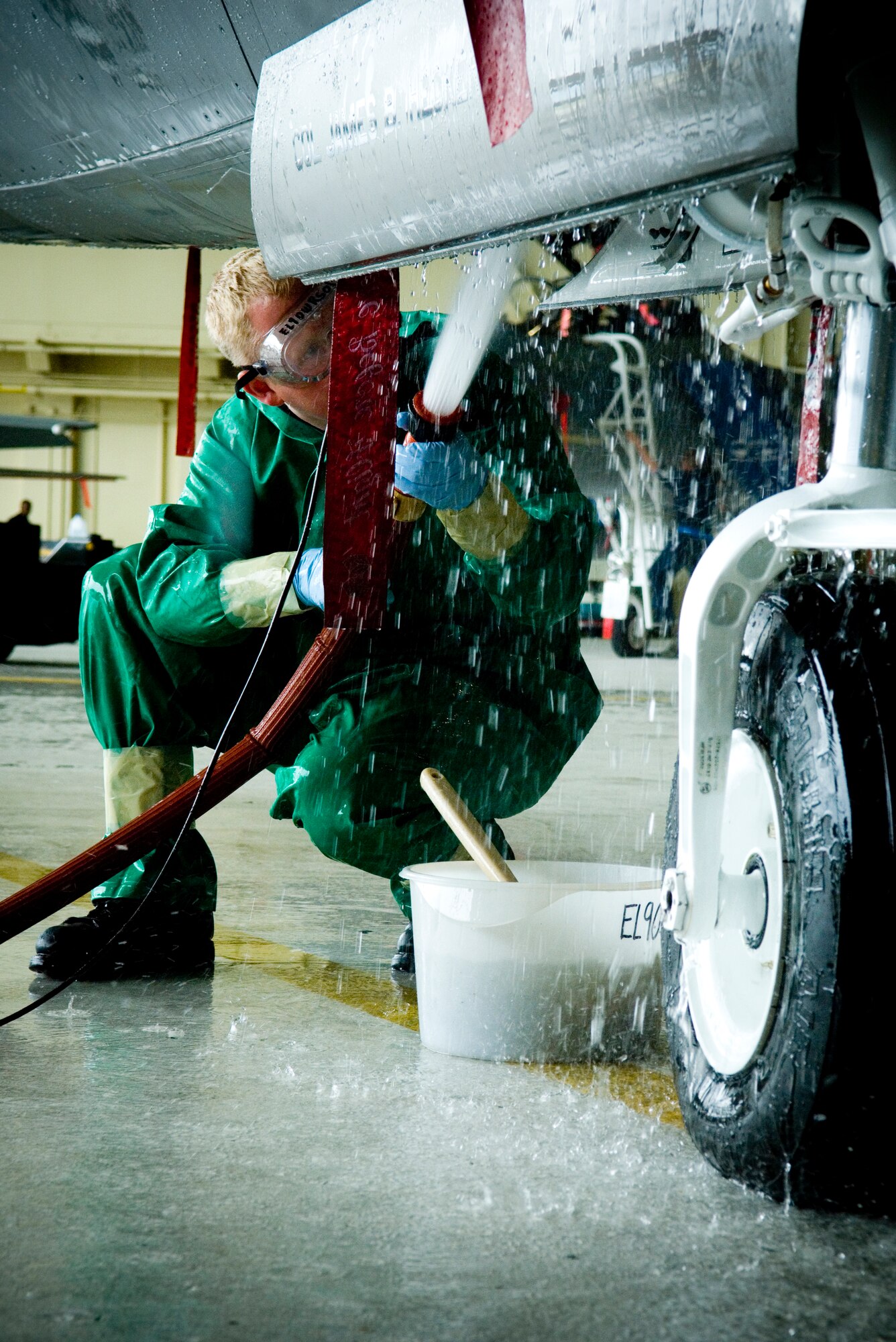ELMENDORF AIR FORCE BASE, Alaska - Senior Airmen Michael Doane cleans out the grime in the landing gear of an F-22A Raptor belonging to the 90th Fighter Squadron here. The aircraft was washed for the first time Aug. 14 since arriving here Aug. 8.  Airman Doane is assigned to the 3rd Aircraft Maintenance Squadron, 90th Aircraft Maintenance Unit. (U.S. Air Force photo by Senior Garrett Hothan)