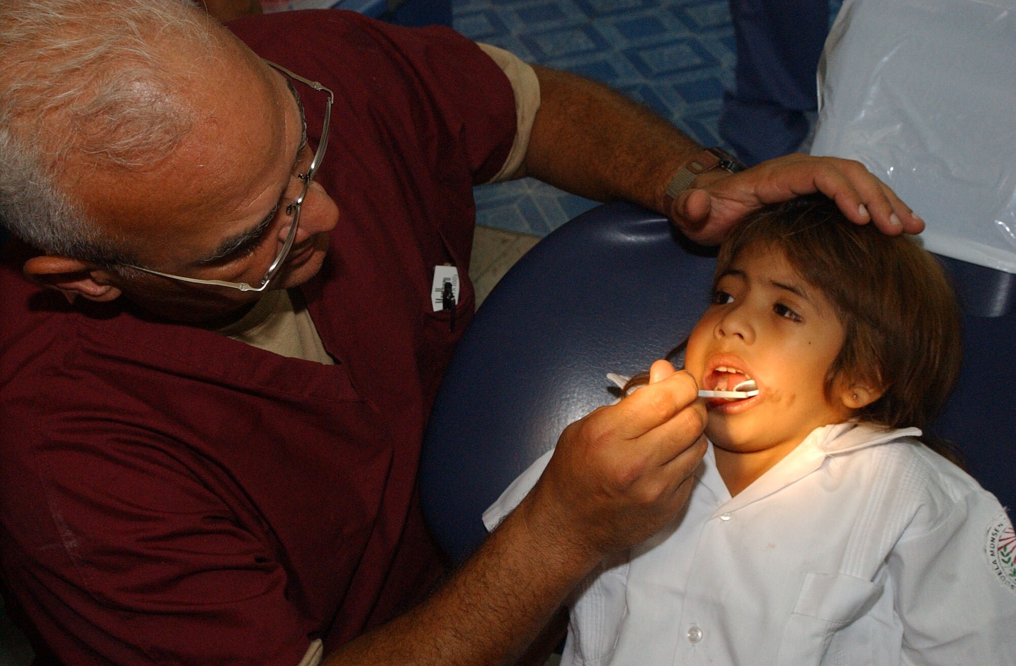 TEGUCIGALPA, Honduras -- Army Lt. Col. (Dr.) Manuel Marien, a pediatric dentist from Fort Hood, Texas, examines the teeth of a Honduran child during a Medical Readiness Training Exercise, or MEDRETE, Aug. 14, 2007.  Soldiers and Airmen are helping hundreds of Honduran children and providing much needed dental care at the Catholic University Dental School here. (US Air Force photo/1st Lt. Erika Yepsen)