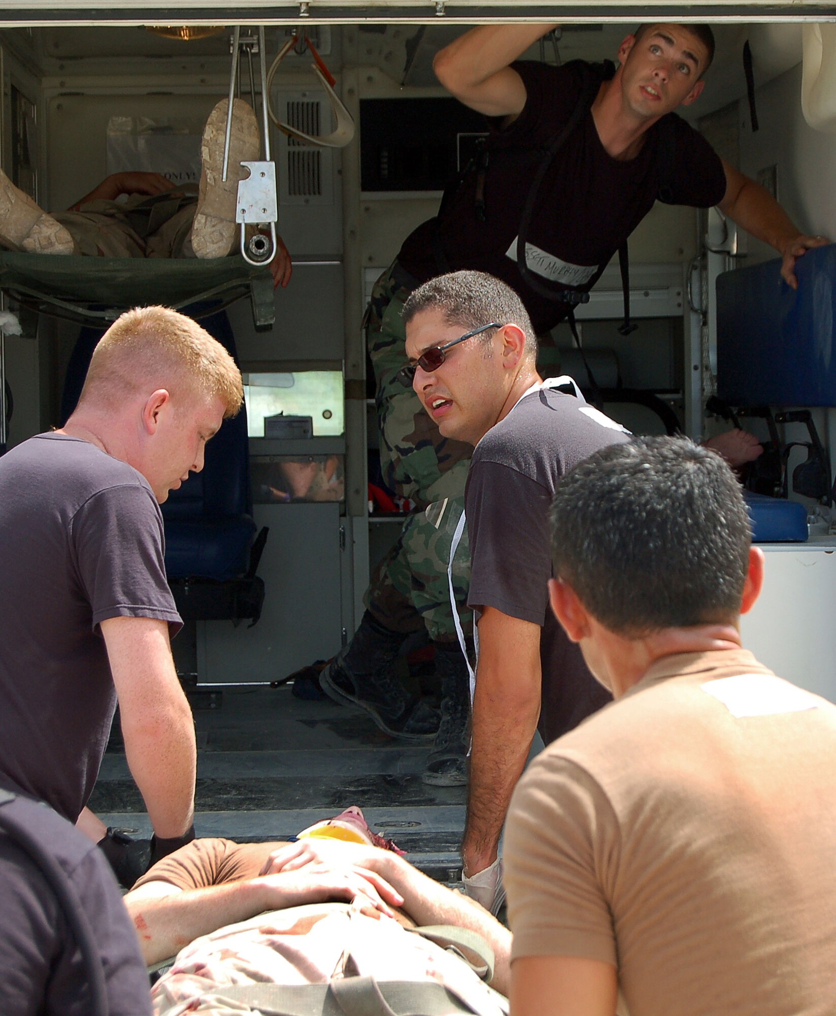 Students attending the Expeditionary Medical Support course at Brooks City-Base, Texas, lift an "accident victim" into an ambulance Aug. 8 during the exercise portion of the class. The one week course is held 20 times a year. (U.S. Air Force Photo/Staff Sgt. Jeremy Larlee) 