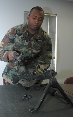 Senior Airman Lionel Coppin, 341st Missile Security Forces Squadron, changes a barrel on an M-240B machine gun during the classroom portion of a class held at Malmstrom Air Force base's Combat Arms Training and Maintenance facility Aug. 13, 2007.  (U.S. Air Force photo by Airman 1st Class Dillon White)          
