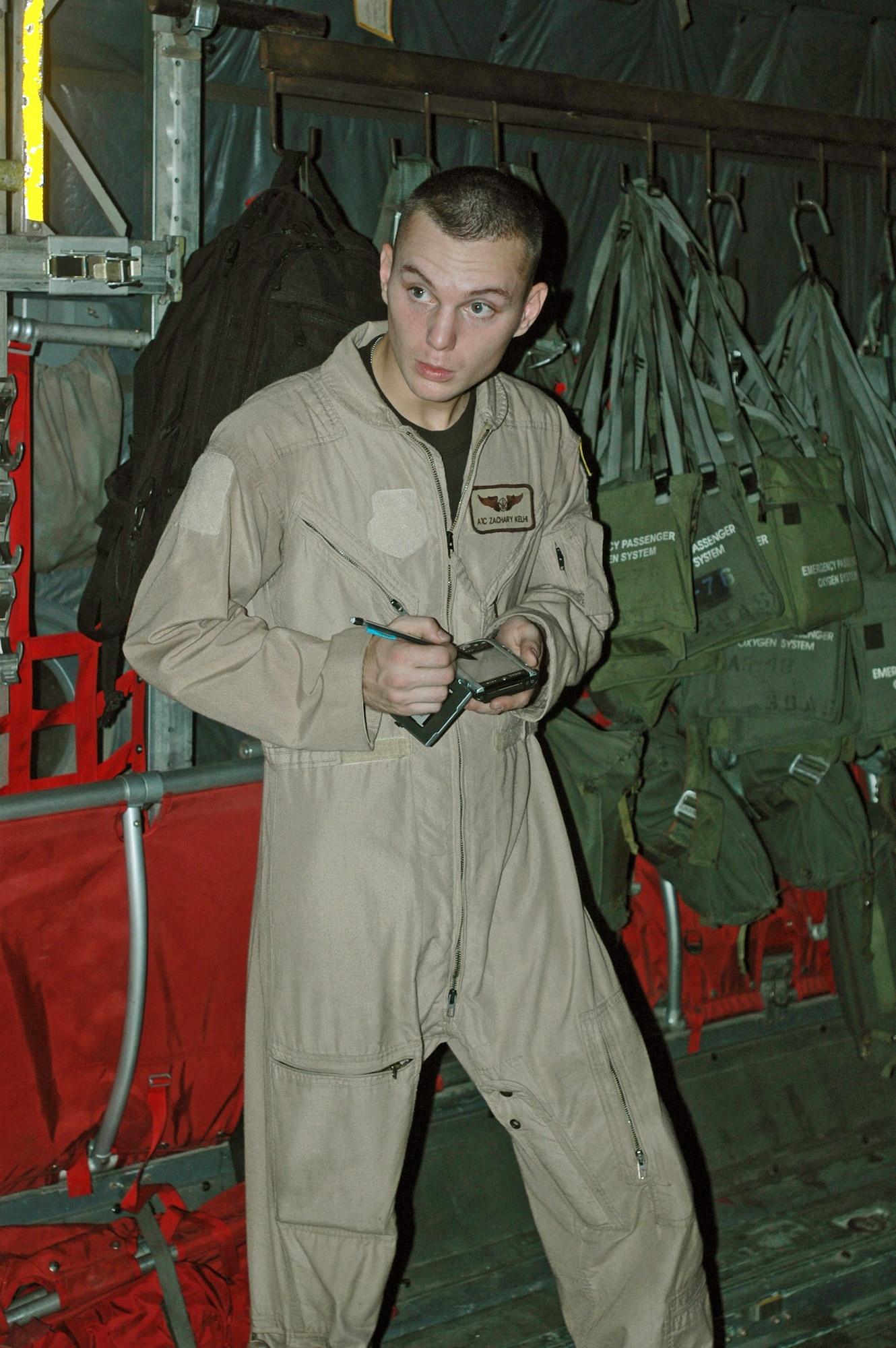 Airman 1st Class Zachary Kelhi calculates weights and balances of cargo to be loaded onto his C-130 Hercules for a flight from Balad Air Base, Iraq, to Baghdad International Airport.  Airman Kelhi is a loadmaster with the 746th Expeditionary Airlift Squadron.  (U.S. Air Force photo/Capt. Teresa Sullivan) 
