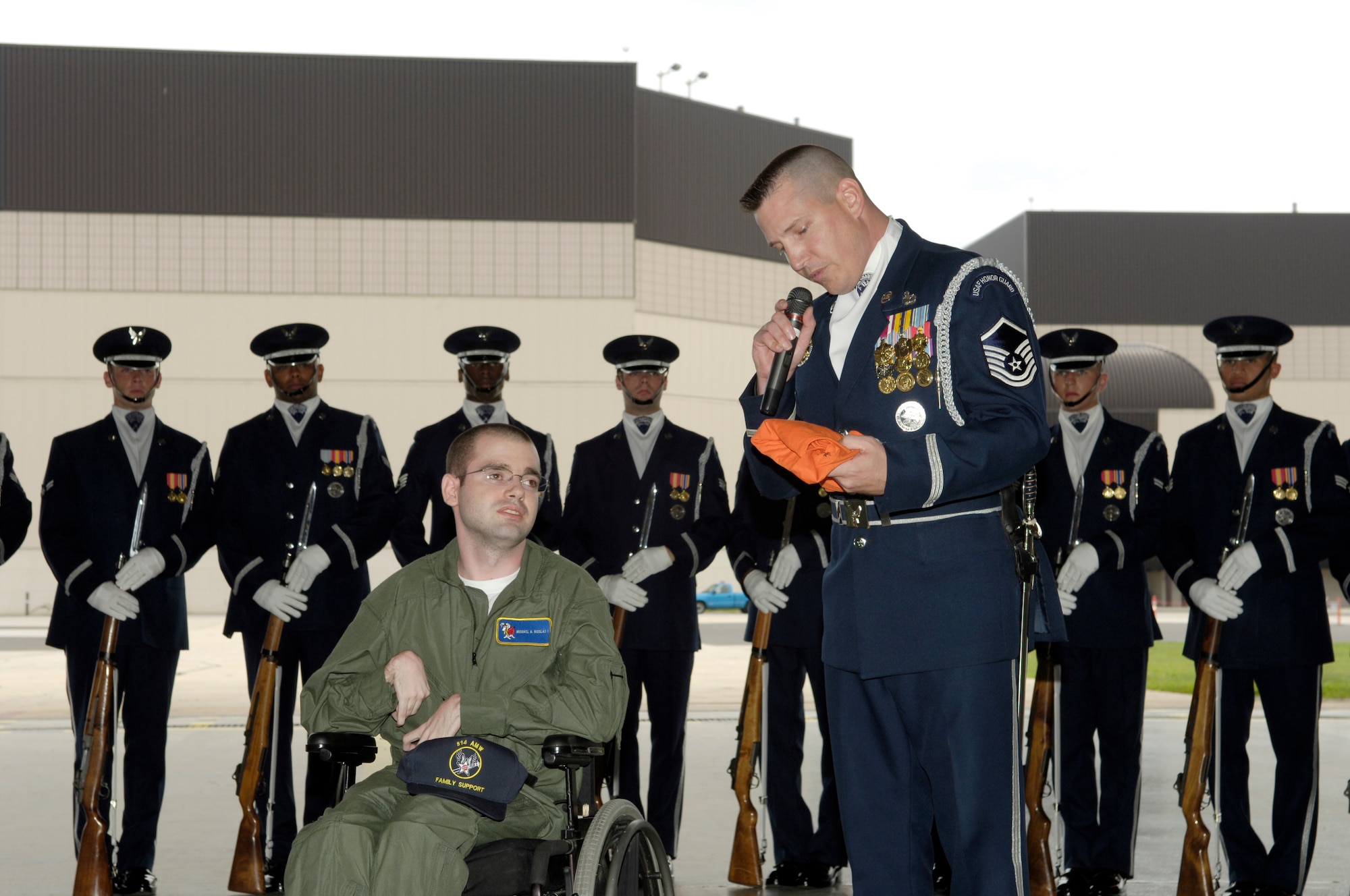 Master Sgt. Jacob Pullin, Air Force Honor Guard NCO in charge, Bolling Air Force Base, Washington, D.C., presents Michael Nicolas a shirt signed by the members of the Honor Guard after an exhibition at a recruiting event here.  Nicolas, son of Master Sgt. (ret.) Michael Nicolas, was the 514th Air Mobility Wing “Hero for a Day”. (U.S. Air Force photo by Kenn Mann)