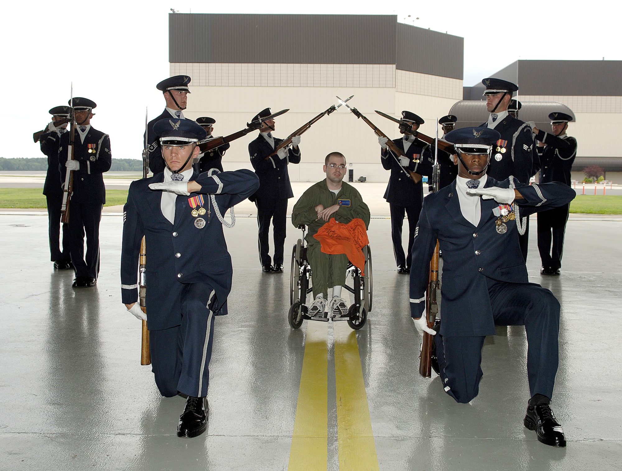A formation of the Air Force Honor Guard from Bolling Air Force Base, Washington, D.C., poses Michael Nicolas after an exhibition at a recruiting event here. Nicolas, son of Master Sgt. (ret.) Michael Nicolas, was the 514th Air Mobility Wing “Hero for a Day”. (U.S. Air Force photo by Kenn Mann) 