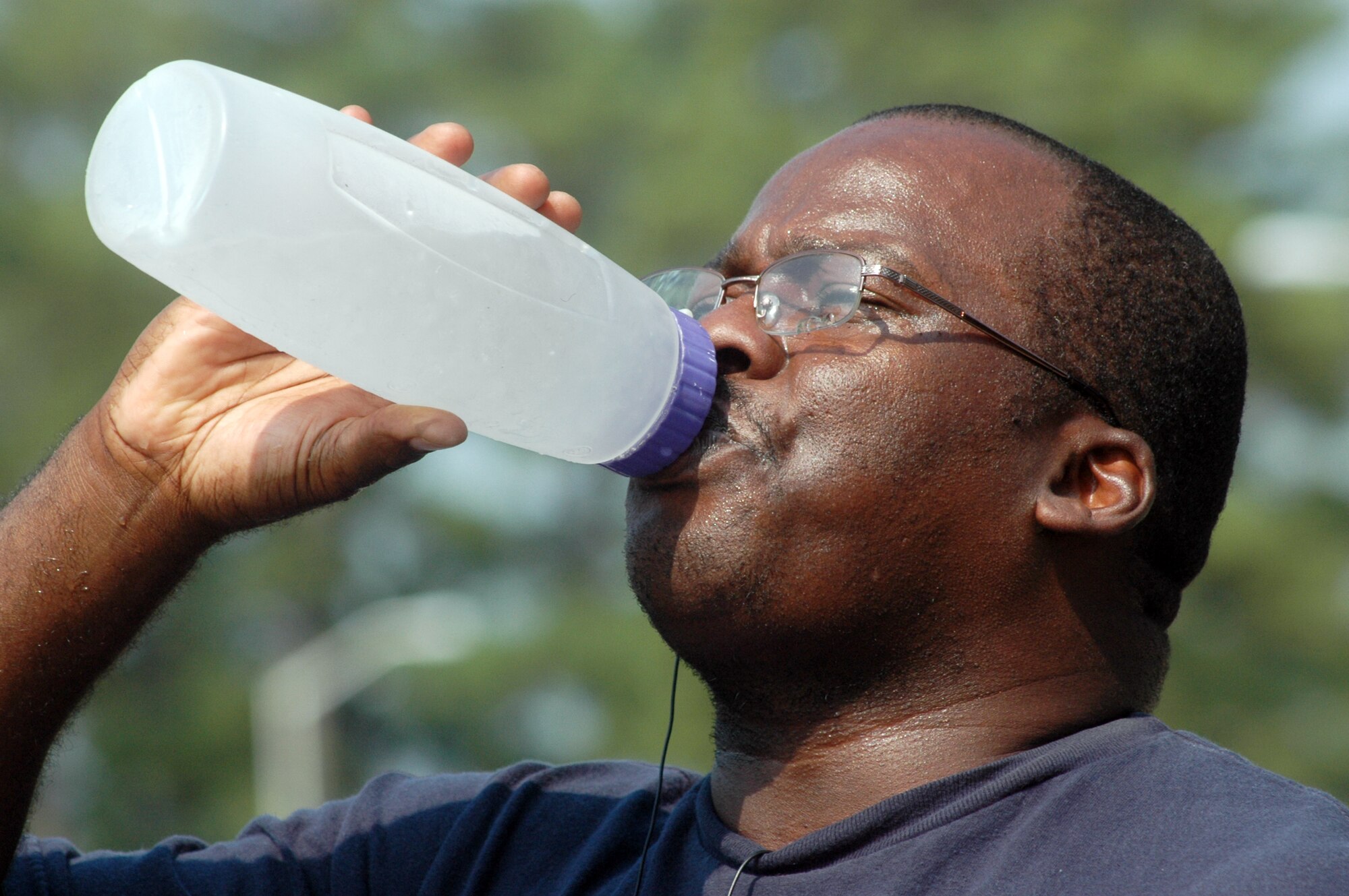 Joey Kornegay hydrates with some water after a morning of outdoor exercise. U. S. Air Force photo by Sue Sapp