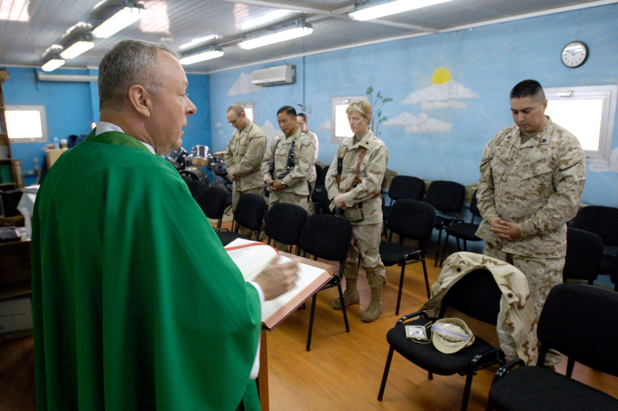 Chaplain (Lt. Col.) Michael Weber leads the Catholic daily mass July 23 at Camp Eggers in Kabul, Afghanistan.  Besides providing the various chaplain services to the joint military community at Camp Eggers, Chaplain Weber also serves as a mentor to the Afghan Religious and Cultural Affairs officers, who are the Afghan equivalent to U.S. military chaplains. Chaplain Weber is deployed from Hickam Air Force Base, Hawaii.  (U.S. Air Force photo/Master Sgt. Jim Varhegyi)