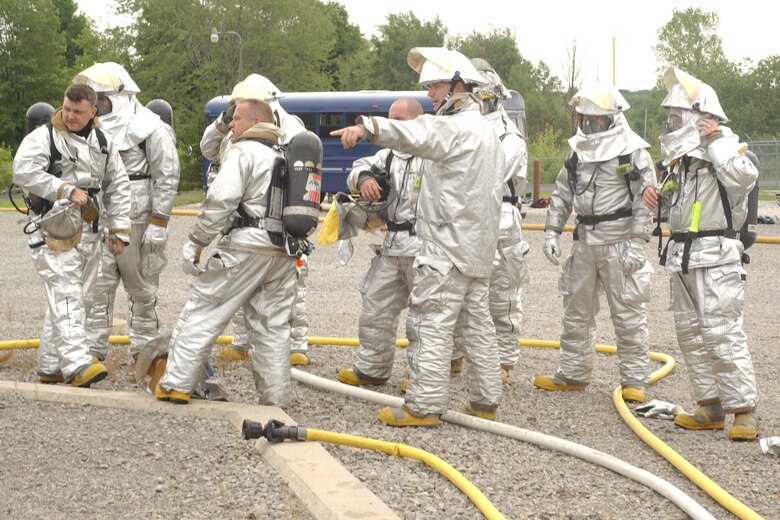 YOUNGSTOWN AIR RESERVE STATION, Ohio -- 910th Airlift Wing firefighters team up with Air National Guard firefighters from the 179th Airlift Wing, Mansfield Air National Guard Base, Ohio, Aug. 14, to fight a simulated aircraft fire at the base fire training facility here.  The training was to coincide with the Guard unit's annual FAA training requirements.  (U.S. Air Force photo/SrA. Clint Kline)                               