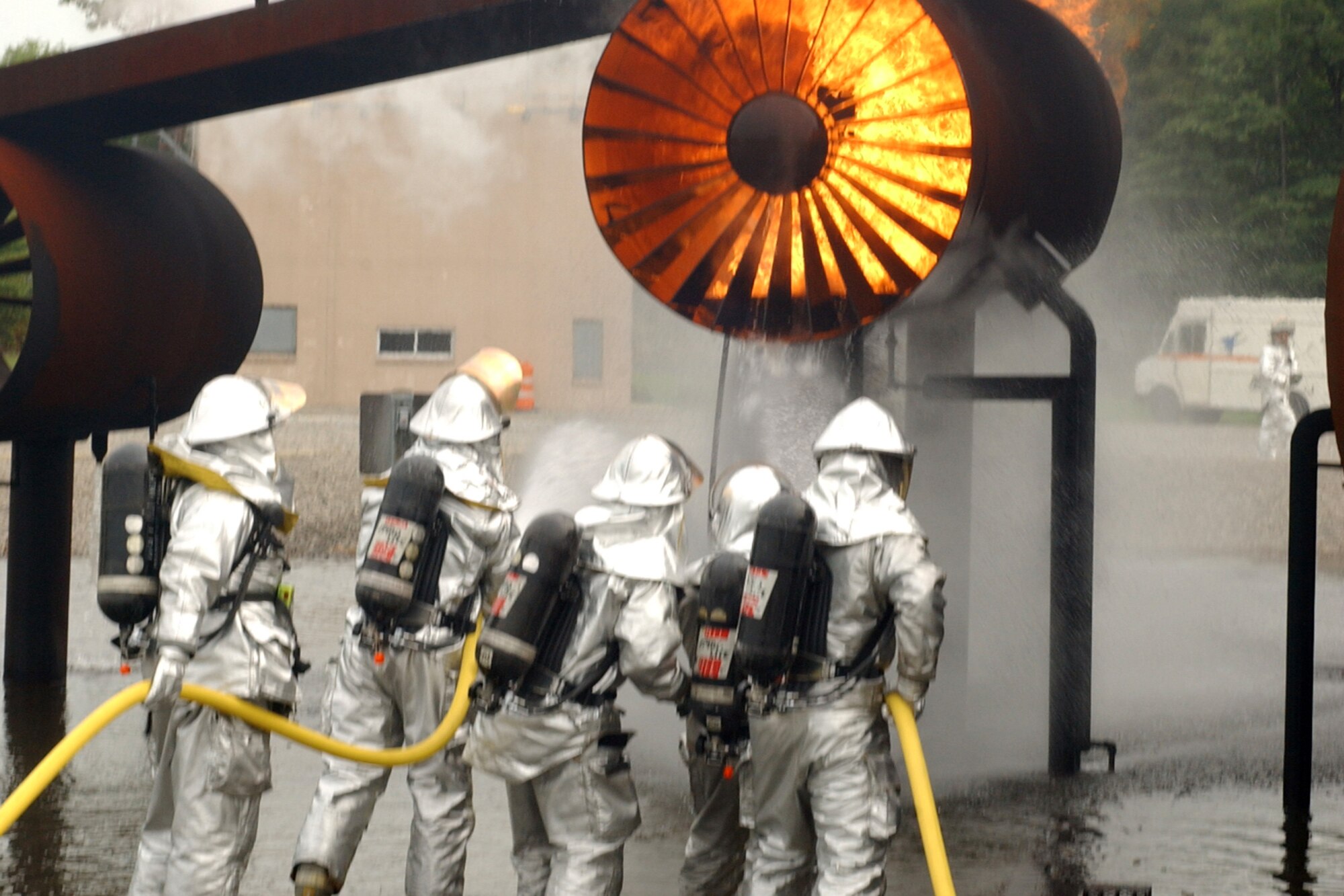 YOUNGSTOWN AIR RESERVE STATION, Ohio -- 910th Airlift Wing firefighters team up with Air National Guard firefighters from the 179th Airlift Wing, Mansfield Air National Guard Base, Ohio, Aug. 14, to fight a simulated aircraft fire at the base fire training facility here.  The training was to coincide with the Guard unit's annual FAA training requirements.  (U.S. Air Force photo/SrA. Clint Kline)