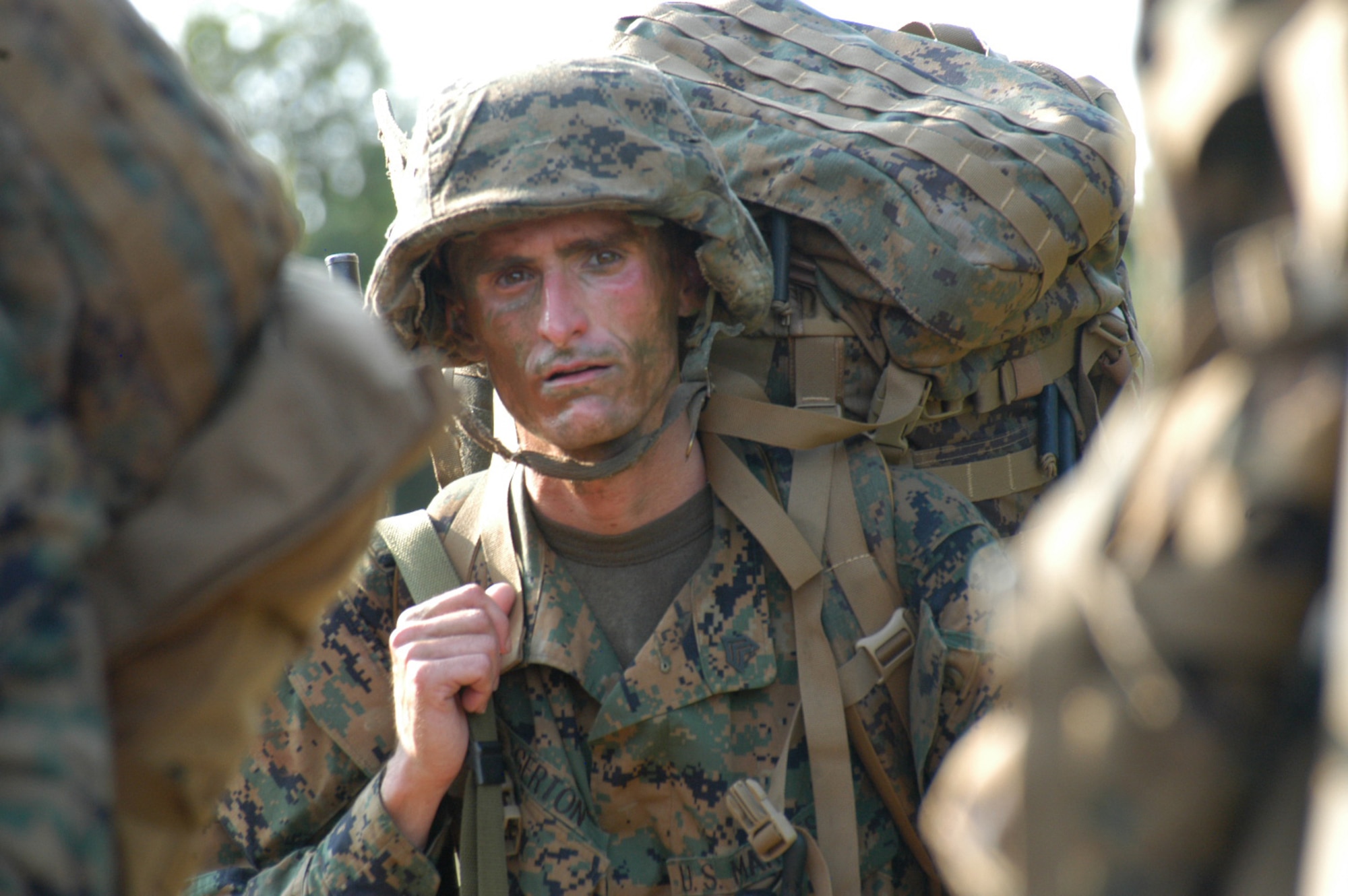 Marine Sergeant Justin Agerton, Det-1, MTMC, humps a 60-lb rucksack for five miles during field training at Camp Bowie, Texas, Aug. 3. (U.S. Air Force Photo by Senior Airman Carolyn Viss                                 