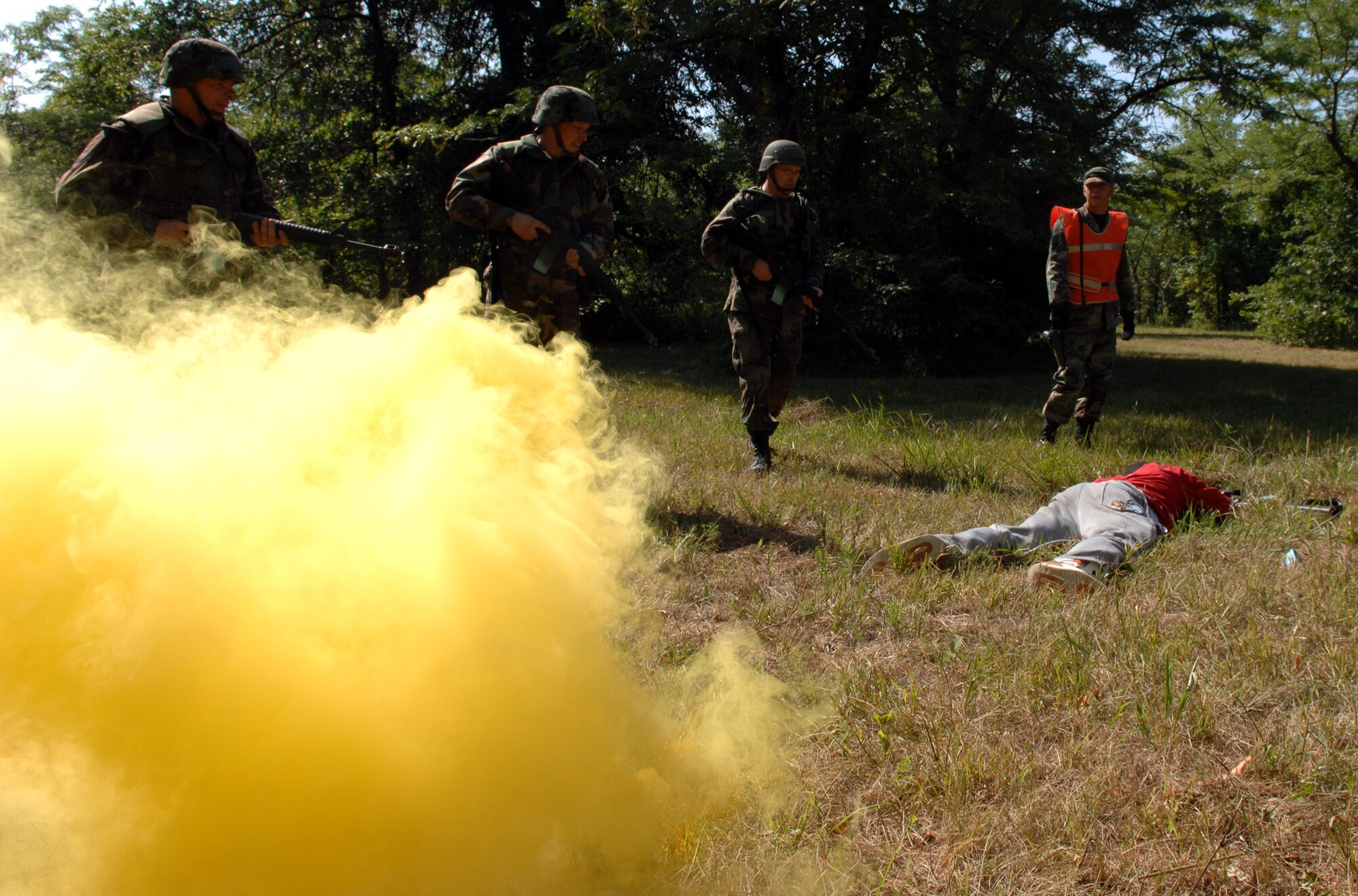 A team of Airmen run sweeps for insurgents with the supervision of Staff Sgt.Tomie Henson, 509th Security Forces and AECS instructor, at the Cobra Site after a mock attack on their convoy during Air Expeditionary Combat Skills training Aug. 10. (U.S. Air Force photo/Airman 1st Class Stephen Linch)