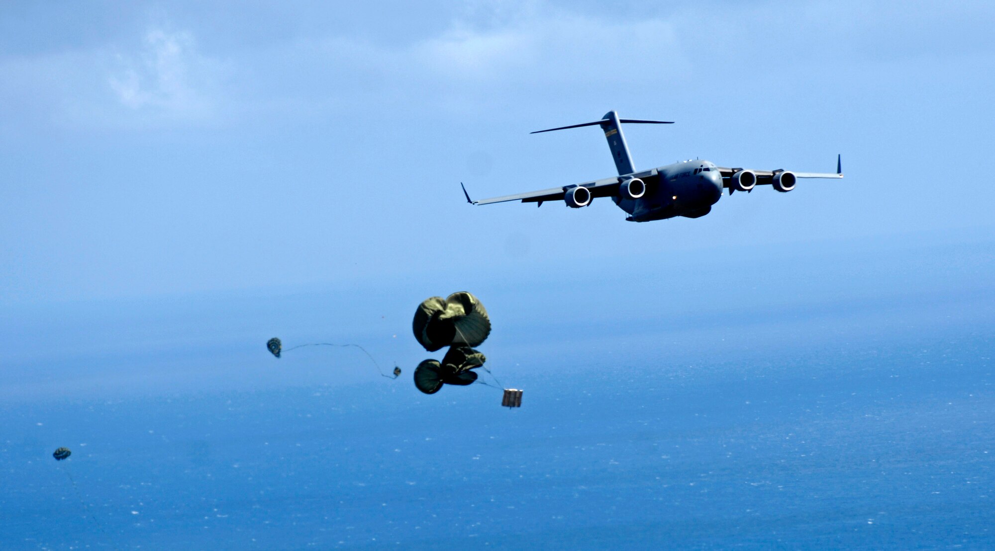 A C-17 Globemaster III releases a practice pallet during a four-ship, airdrop training mission Aug. 13 over the island of Oahu, Hawaii. The C-17 is assigned to the 535th Airlift Squadron from Hickam Air Force Base, Hawaii. 535th AS aircrews conducted the multi-element training to maintain currency and proficiency. (U.S. Air Force photo/Tech. Sgt. Shane A. Cuomo)