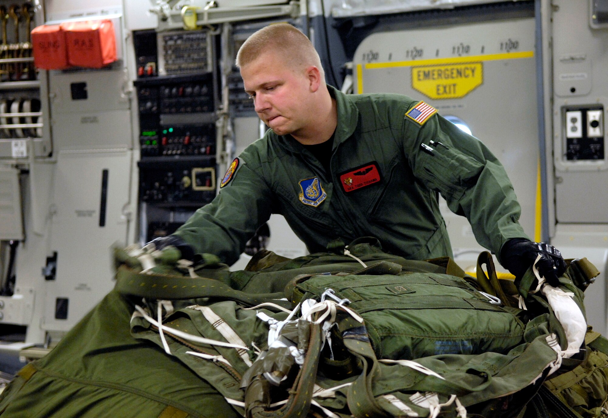 Senior Airman Todd Tichawa prepares to rig an extractions chute on his C-17 Globemaster III Aug. 13 at Hickam Air Force Base, Hawaii. Airman Tichawa, a loadmaster from the 535th Airlift Squadron, is taking part in a four-ship, multi-element airdrop training mission to maintain currency and proficiency. (U.S. Air Force photo/Tech. Sgt. Shane A. Cuomo) 
